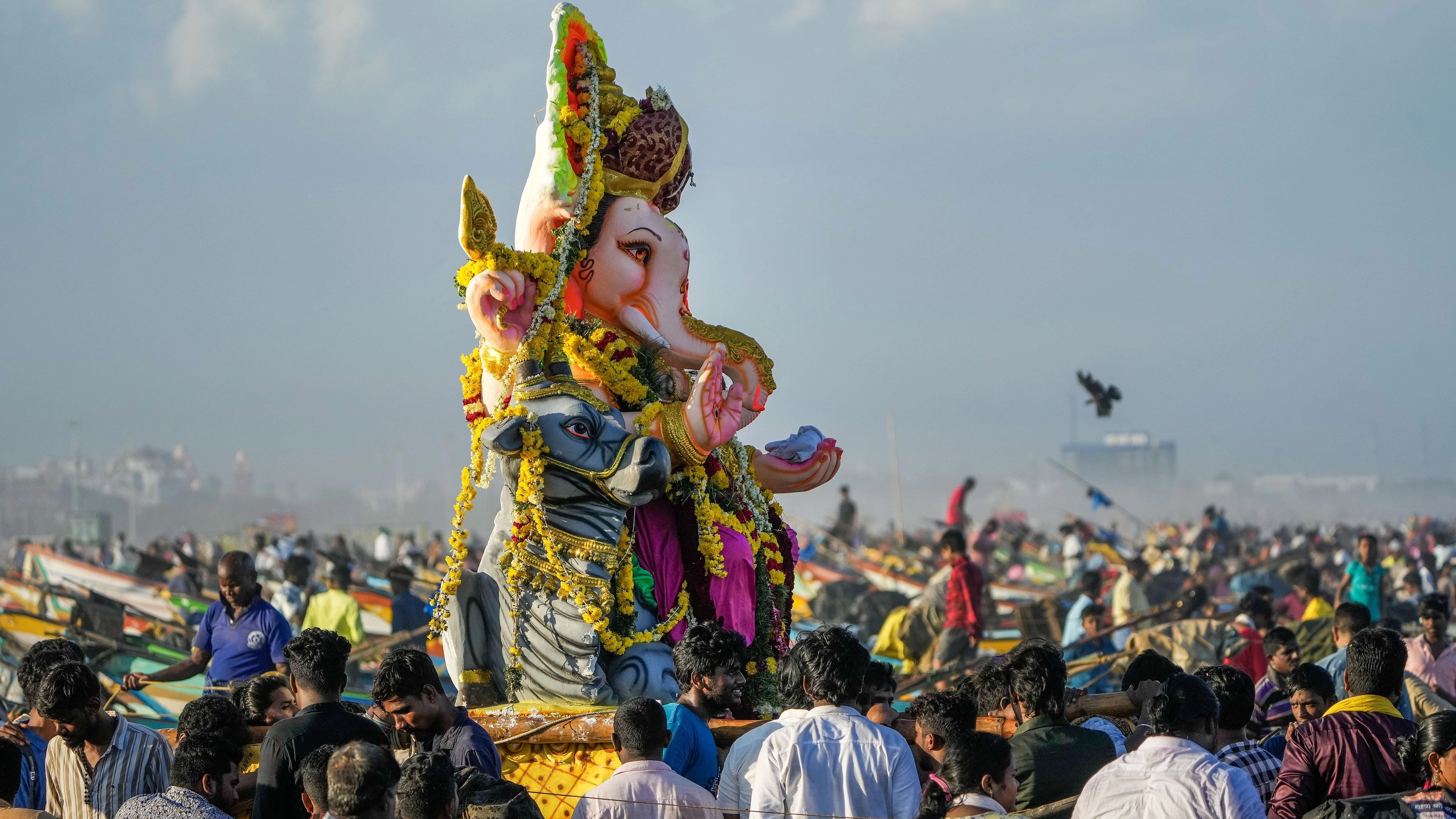 <div class="paragraphs"><p>Devotees carry a Lord Ganesha idol for immersion.</p></div>