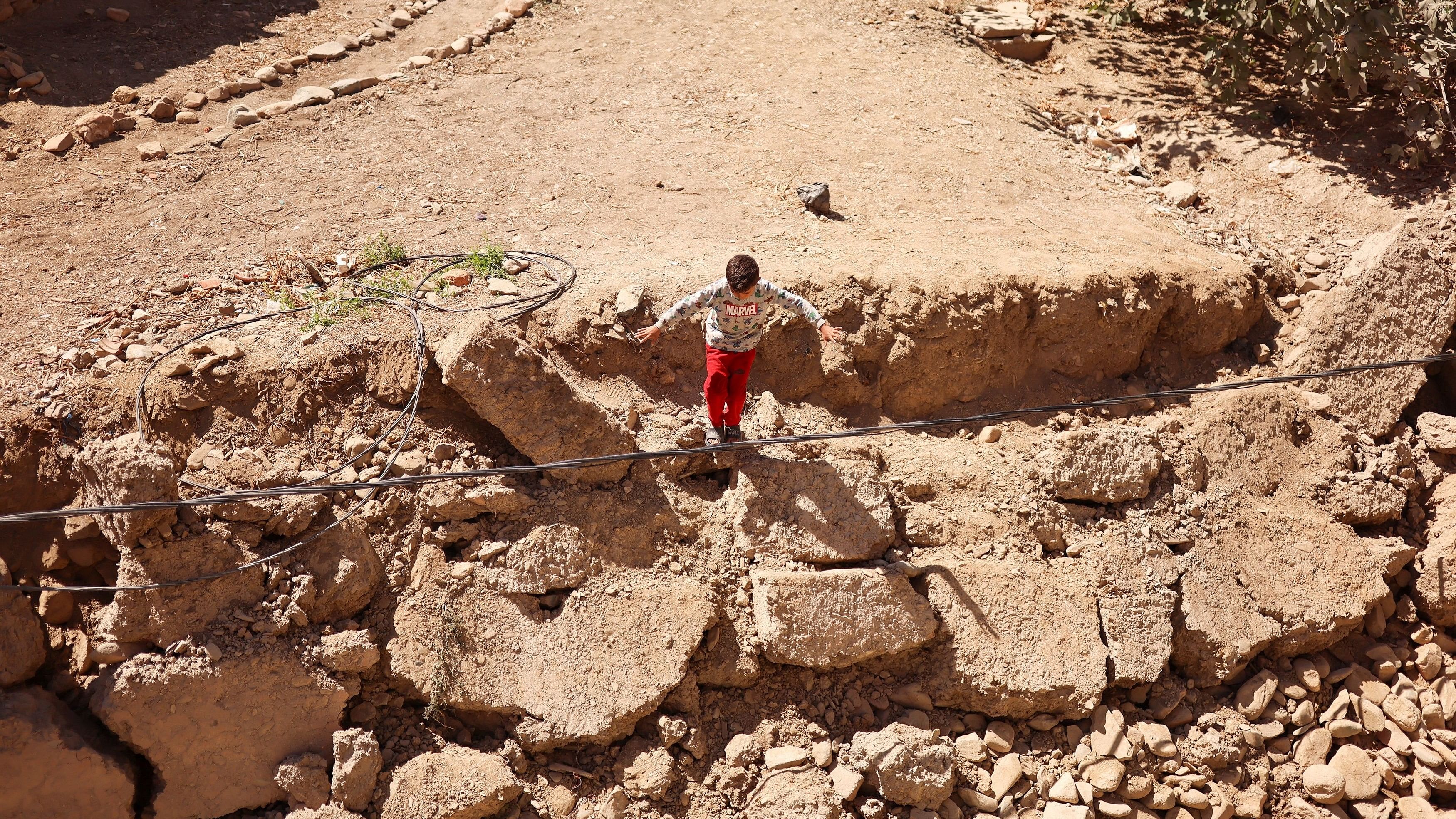 <div class="paragraphs"><p>A boy stands, in the aftermath of a deadly earthquake, in Amizmiz, Morocco, September 10, 2023. </p></div>