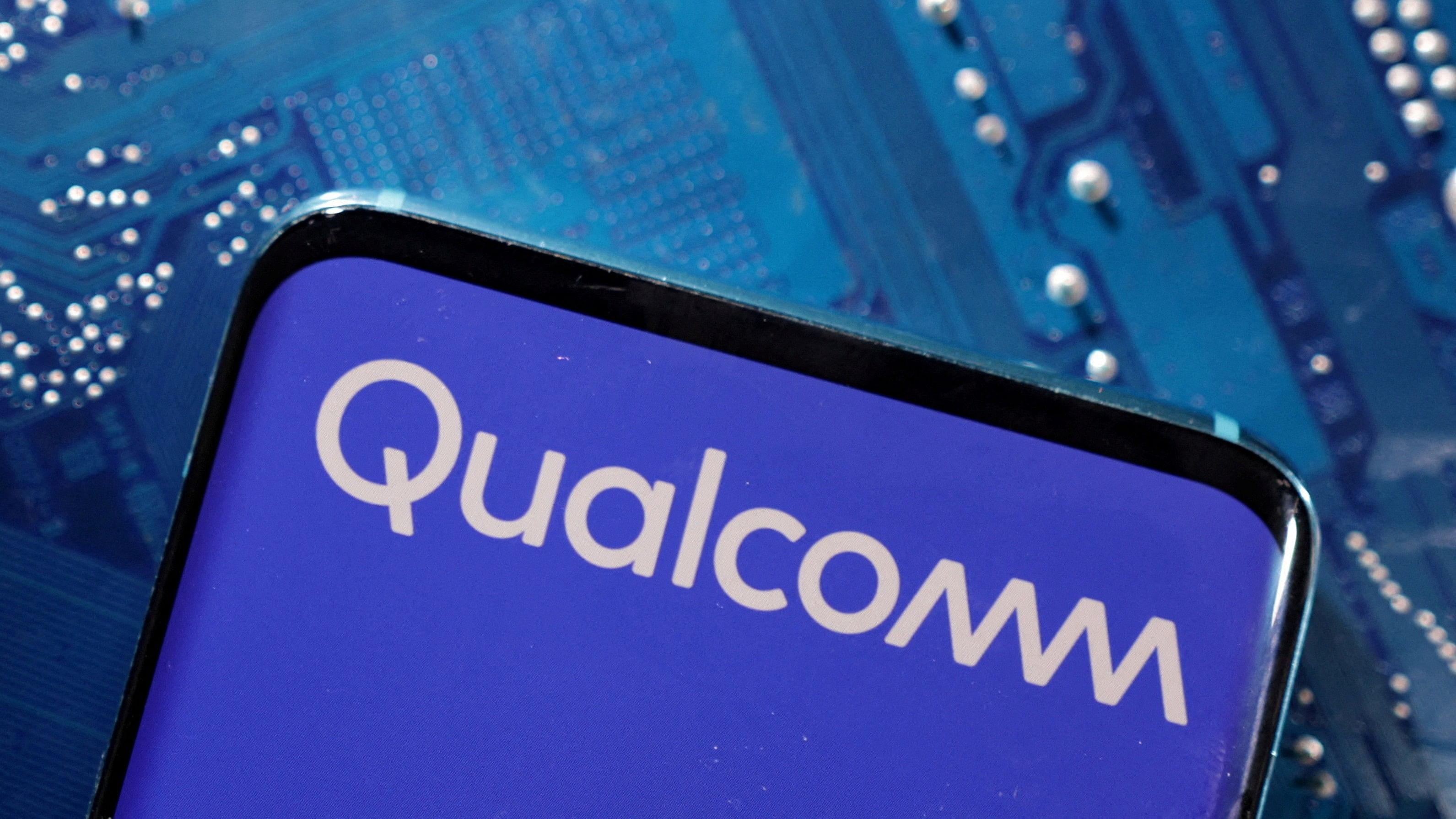 <div class="paragraphs"><p>A smartphone with a displayed Qualcomm logo is placed on a computer motherboard.&nbsp;</p></div>