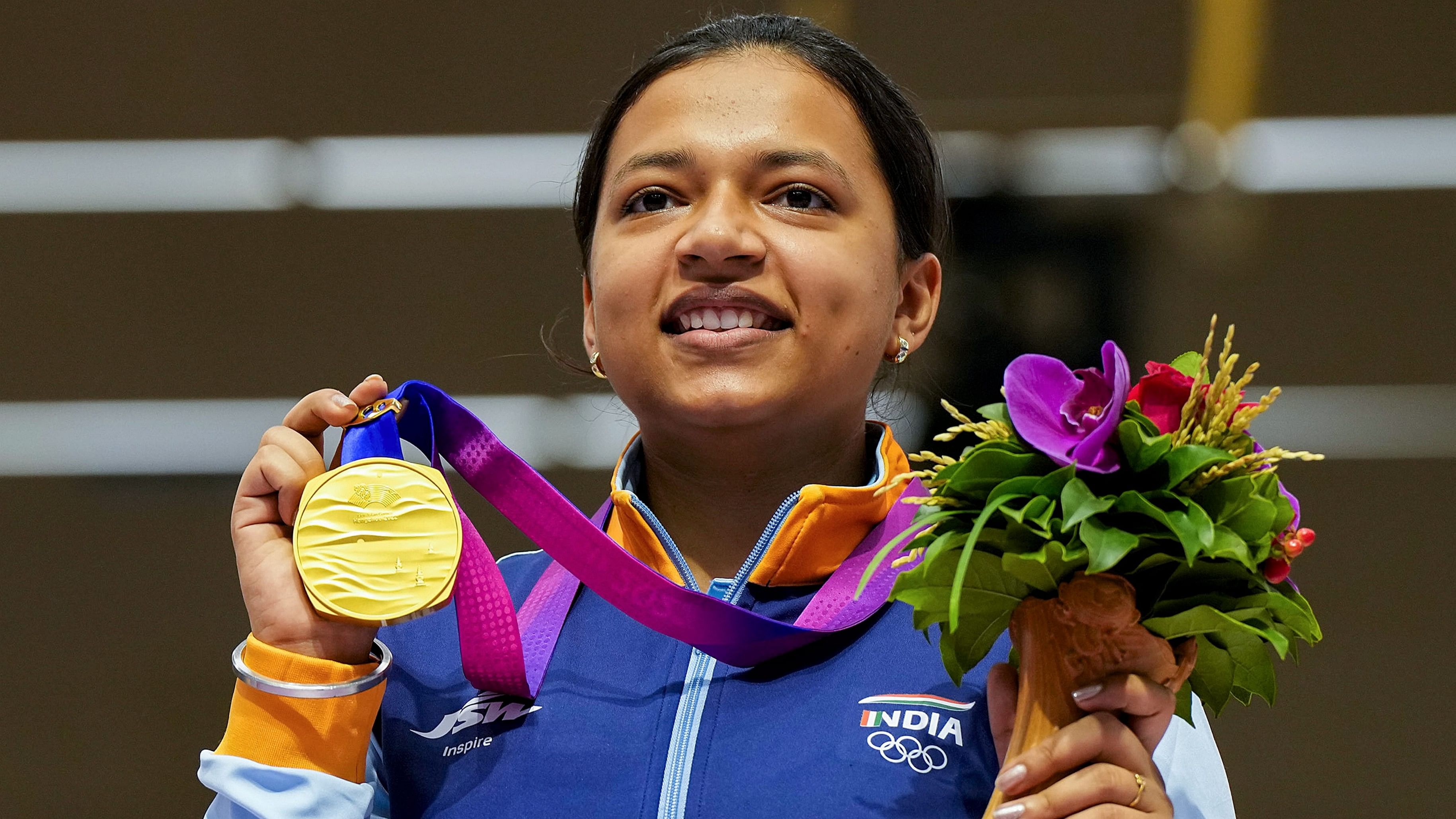 <div class="paragraphs"><p>Shooter Sift Kaur Samra poses for photos with her gold medal during the presentation ceremony of the women's 50m rifle 3 positions event at the 19th Asian Games, in Hangzhou, China.</p></div>
