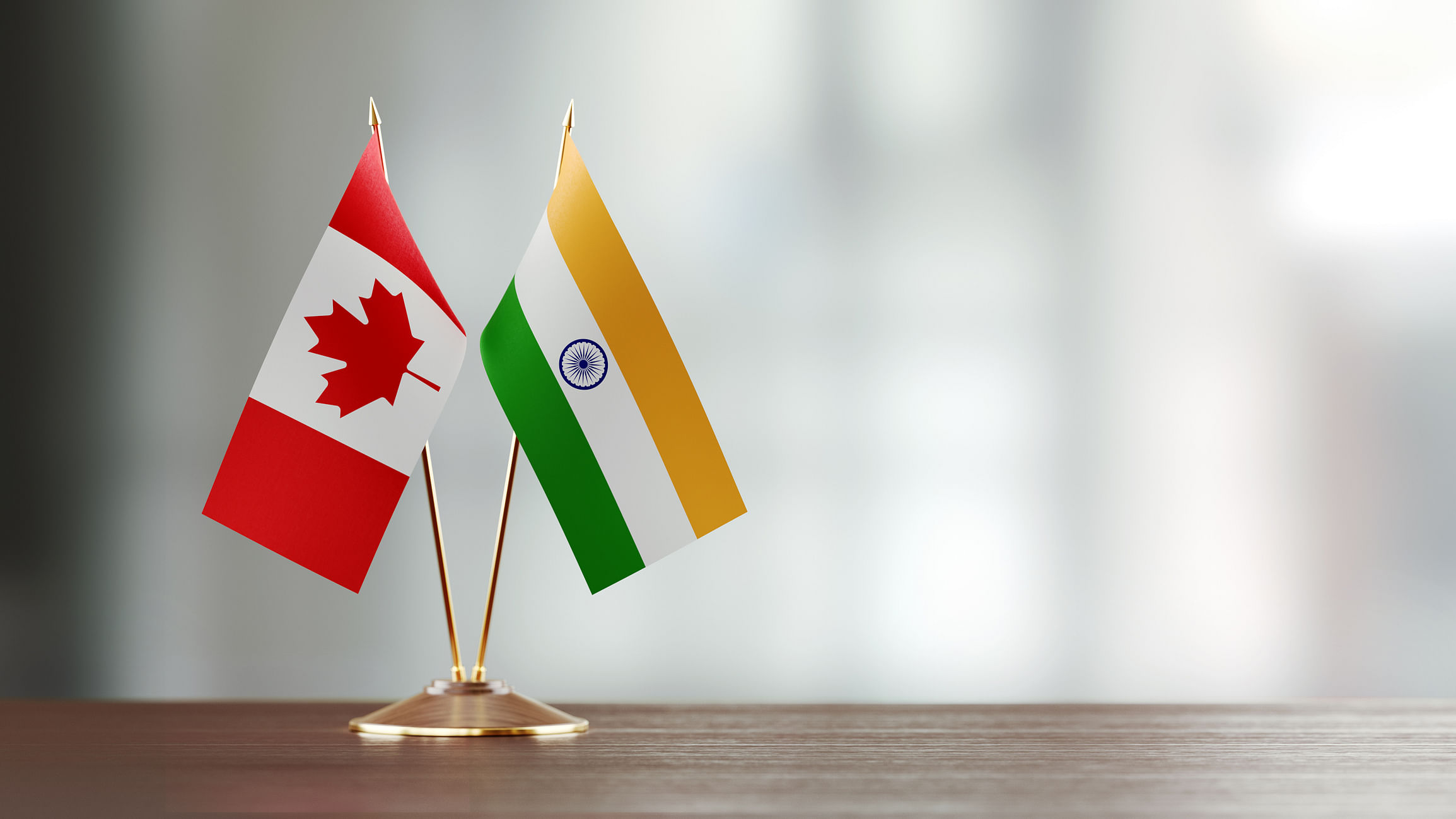 <div class="paragraphs"><p>The flags of Canada and India.</p></div>