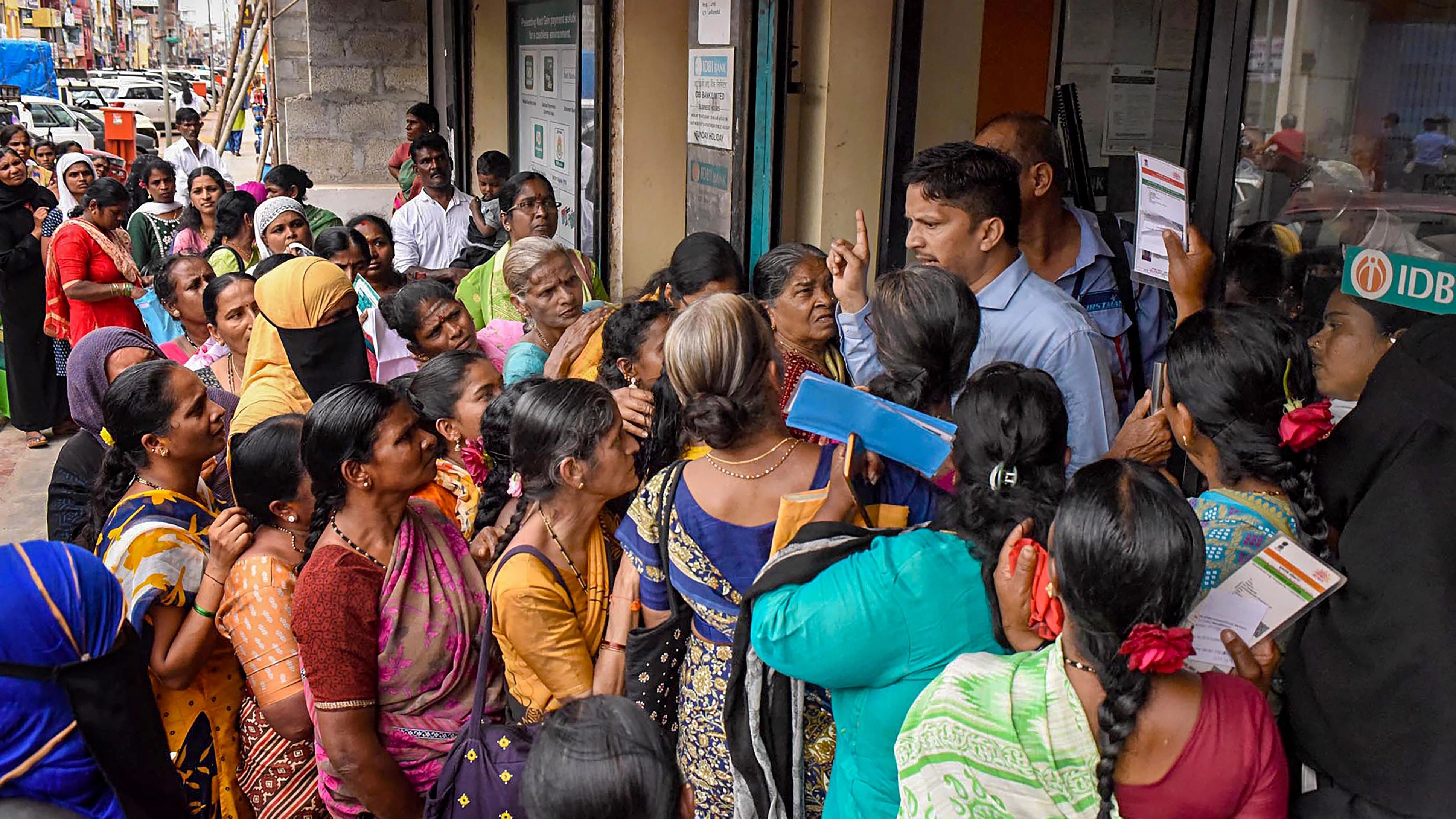 <div class="paragraphs"><p>Women wait in queues at a bank to apply for the Karnataka government's Gruha Lakshmi scheme, in Chikmagalur, Karnataka.</p></div>