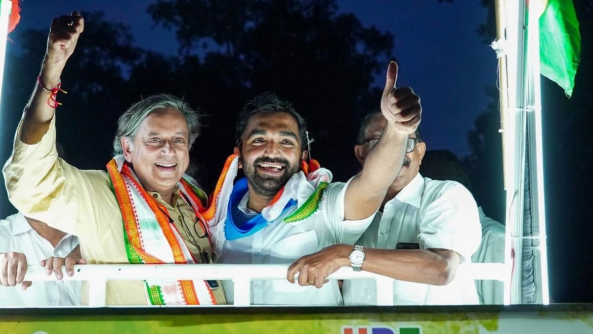 <div class="paragraphs"><p>MP Shashi Tharoor with party candidate  Chandy Oommen during campaign ahead of bypoll.</p></div>