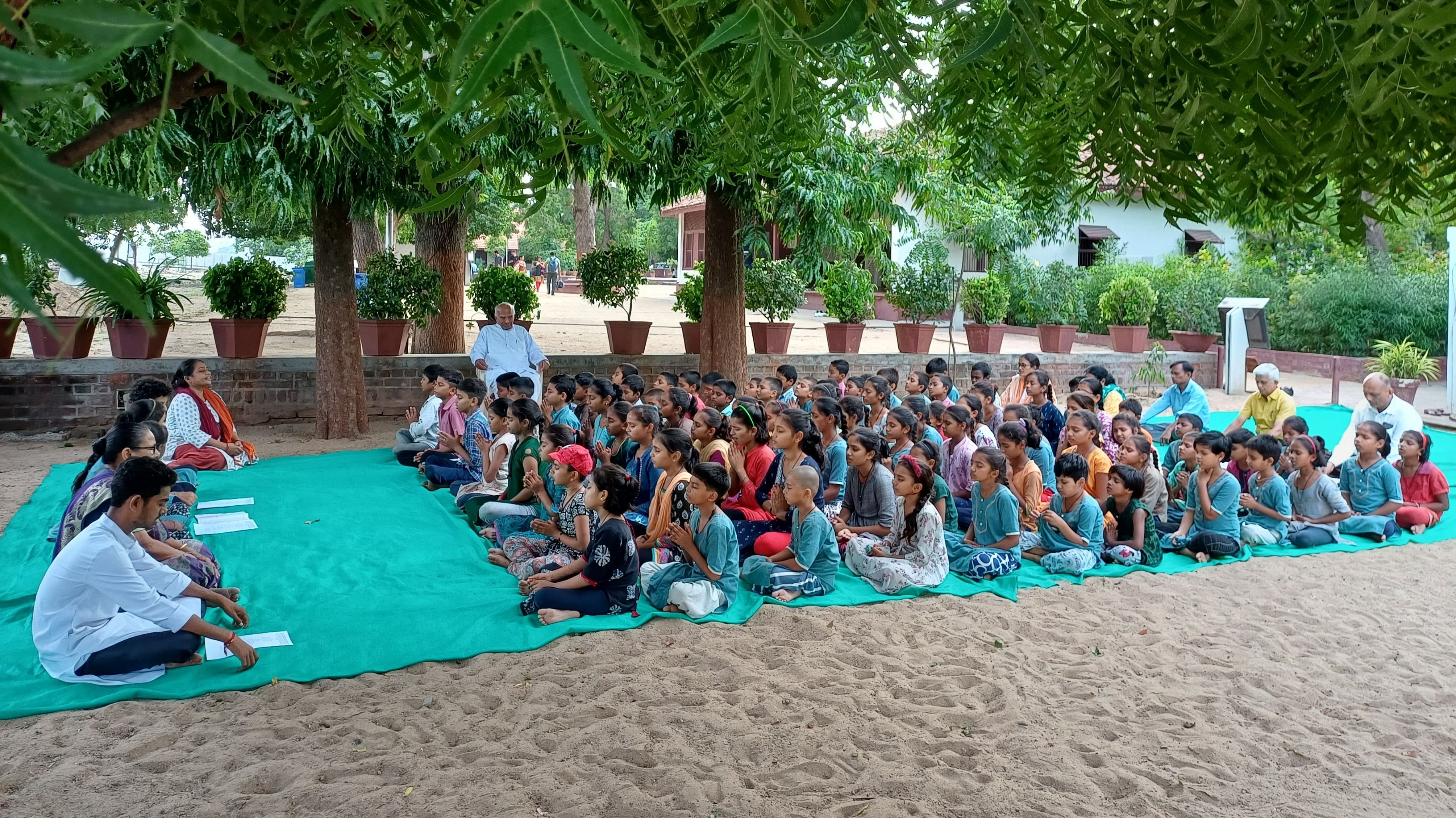 <div class="paragraphs"><p>Ashram staff and children of Harijan Ashram school participating in the daily interfaith prayer at Sabarmati Ashram.</p></div>