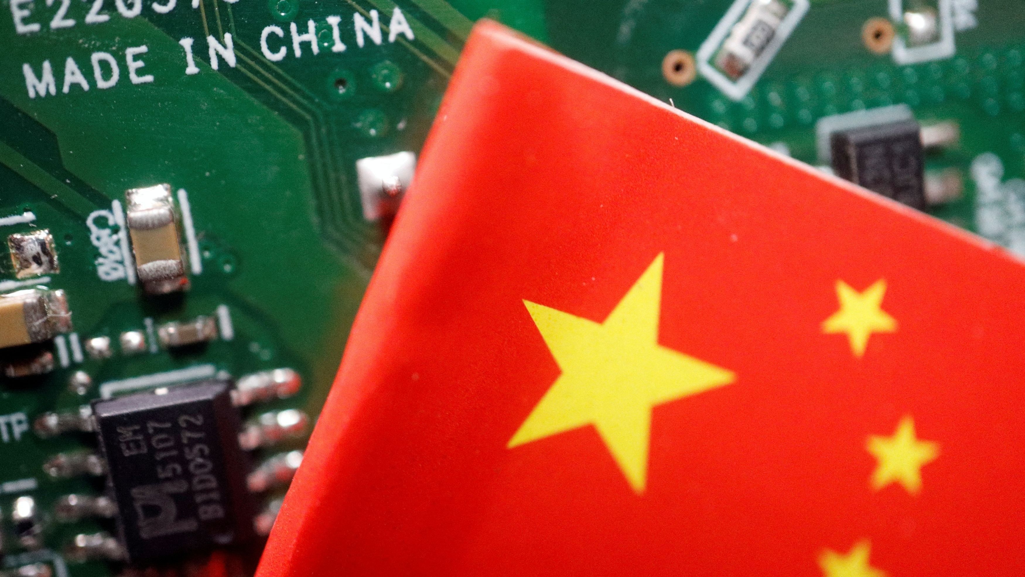 <div class="paragraphs"><p>A Chinese flag is displayed next to a "Made in China" sign seen on a printed circuit board with semiconductor chips, in this illustration.</p></div>