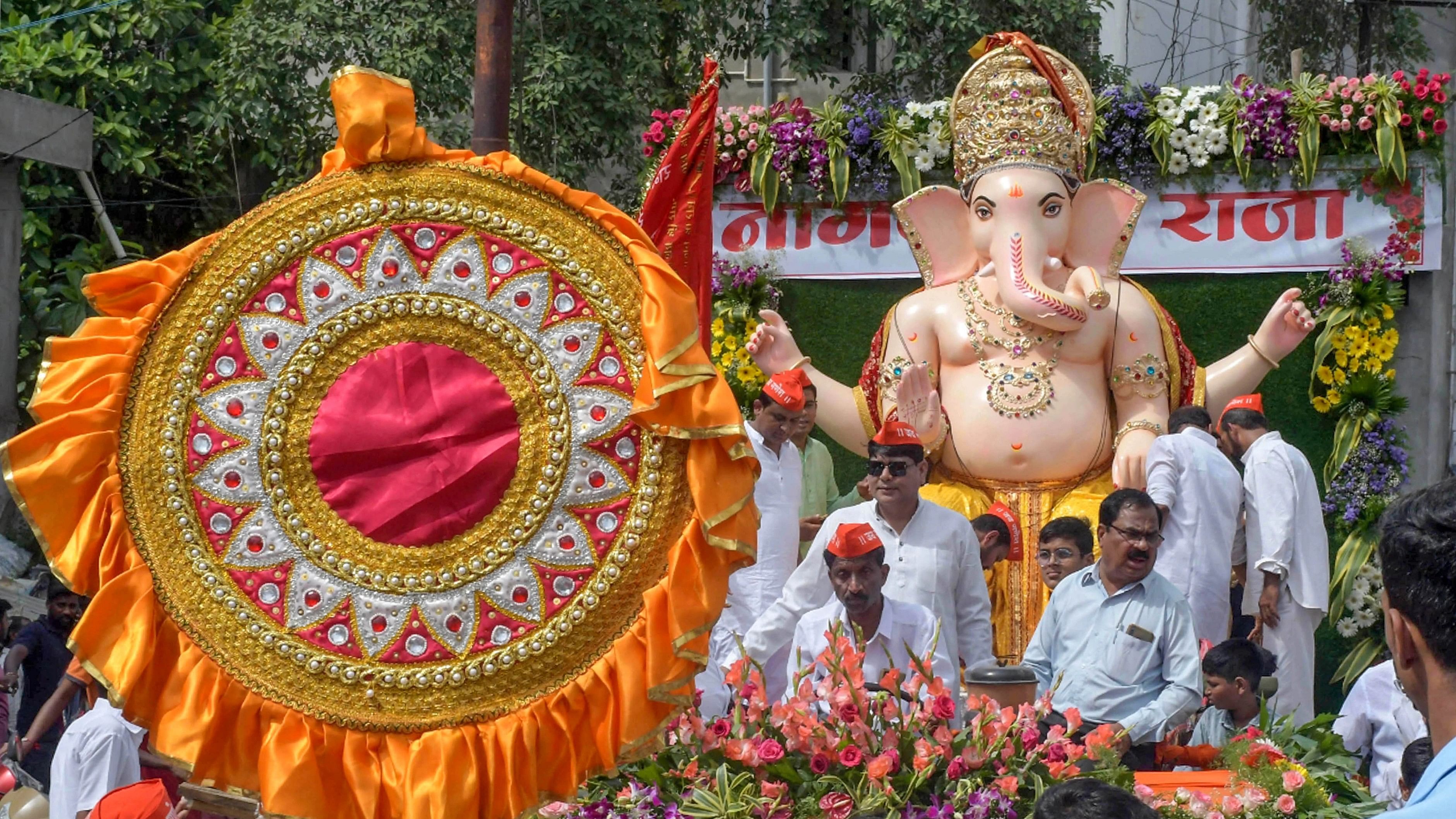 <div class="paragraphs"><p>Devotees carry an idol of Lord Ganesha 'Nagpurka Raja' to a pandal for the Ganesh Chaturthi celebrations, in Nagpur, Sunday.</p></div>