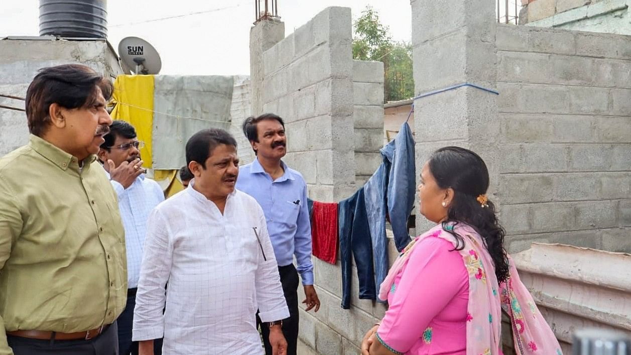 <div class="paragraphs"><p>Housing Minister Zameer Ahmed Khan and officials speak to residents of Kuntigrama near Hebbal. </p></div>
