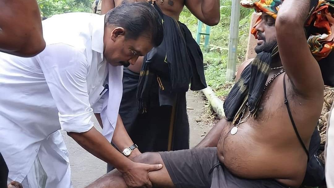 <div class="paragraphs"><p>K Radhakrishnan, Devaswom Minister of Kerala, gives a massage to a Sabarimala devotee.</p></div>