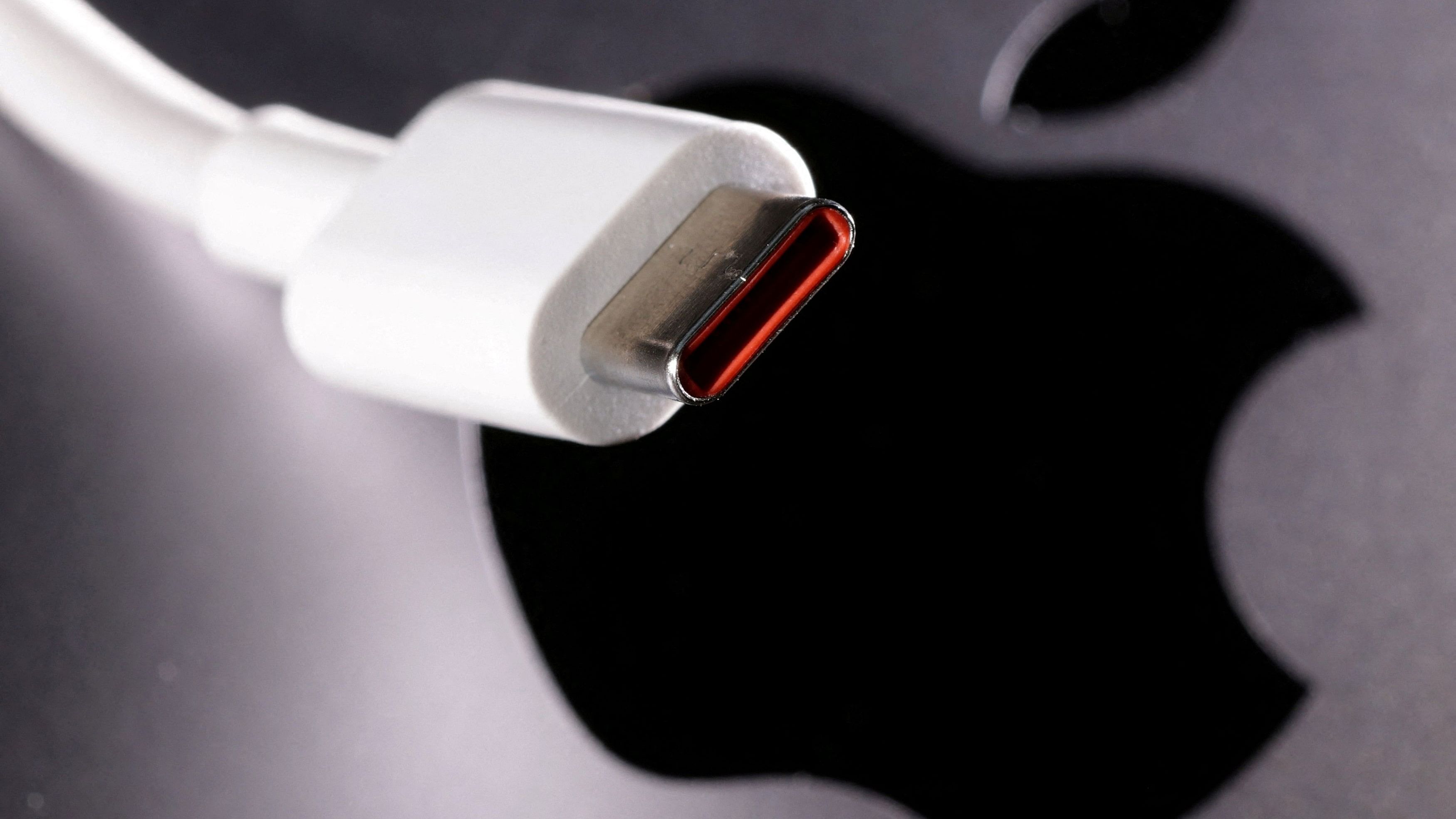 <div class="paragraphs"><p> A USB-C  cable is seen near the Apple logo.</p></div>