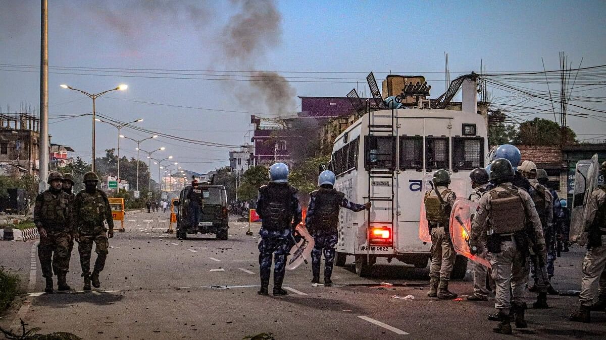 <div class="paragraphs"><p>Security personnel stand guard as students protest against the "killing" of two missing students by unknown miscreants and demand peace in Manipur, Imphal.</p></div>