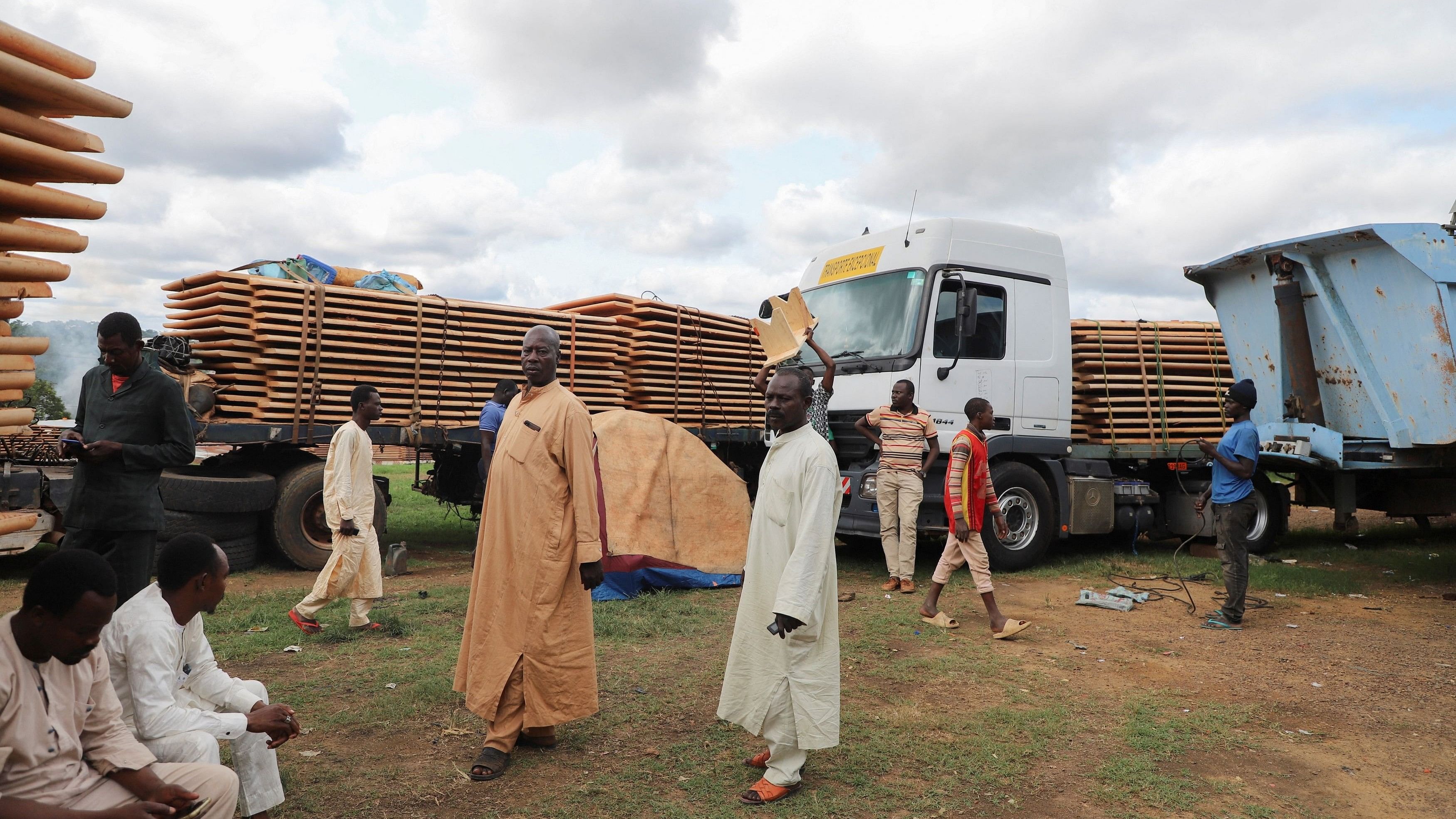 Truck drivers wait near their trucks carrying food, animals and industrial equipments because of the closure of the border after the coup in Gabon, in the border town of Kye-Ossi, Cameroon August 31, 2023. REUTERS/Desire Danga Essigue