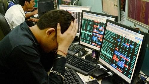 <div class="paragraphs"><p>Share brokers react to falling stock prices on screens of computers and television.</p></div>