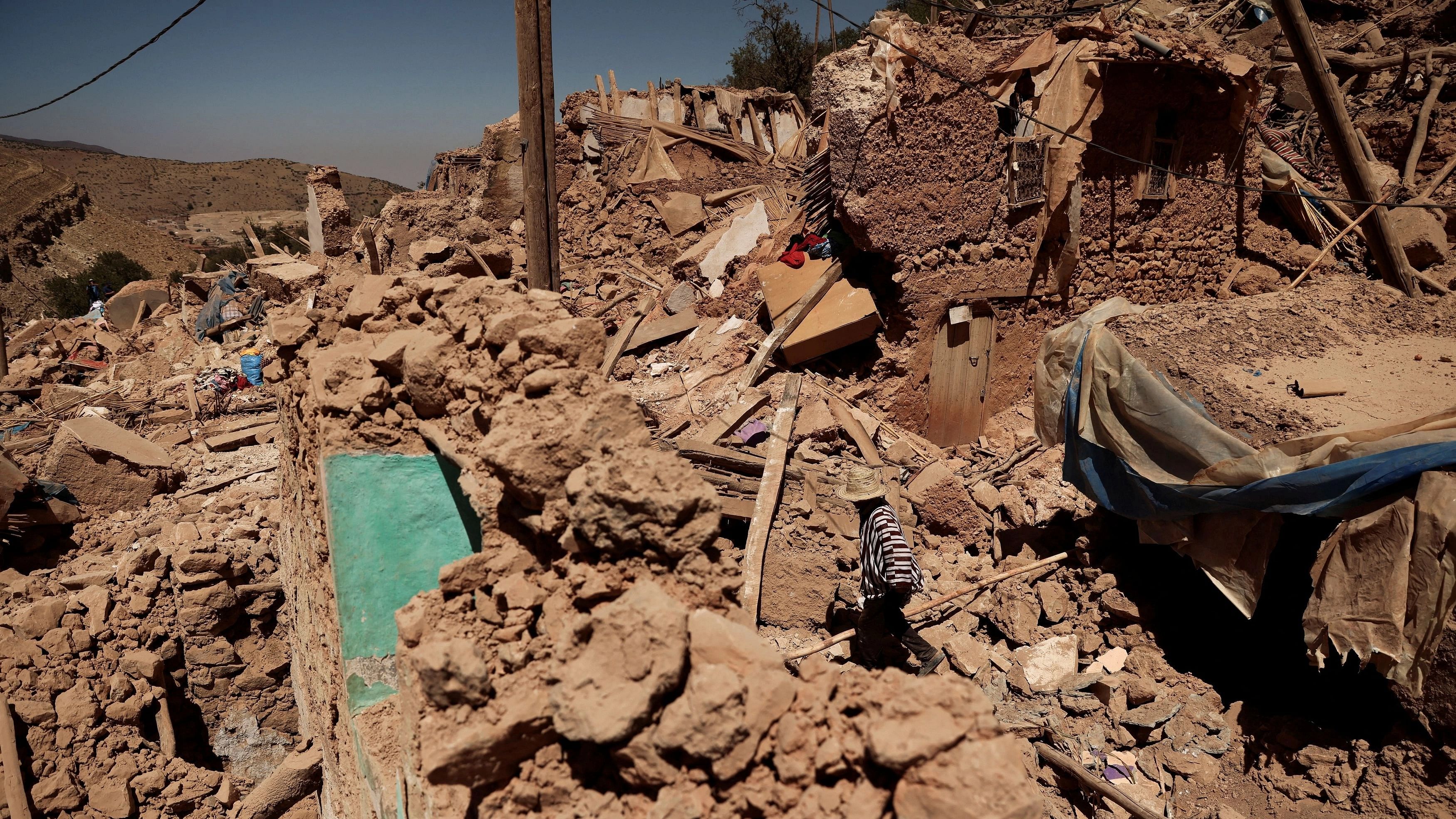 <div class="paragraphs"><p>Mohamed Ouchen, 66, a survivor, who helped to pull his sister and her husband with their children from rubble, walks near his destroyed house, in the aftermath of a deadly earthquake, in Tikekhte, near Adassil, Morocco, September 11, 2023. </p></div>