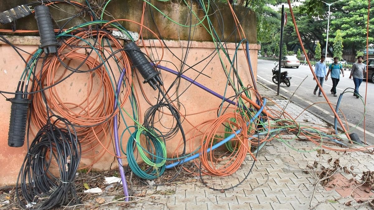 <div class="paragraphs"><p>Cables laid haphazardly on a pavement on Cubbon Road in Bengaluru. </p></div>