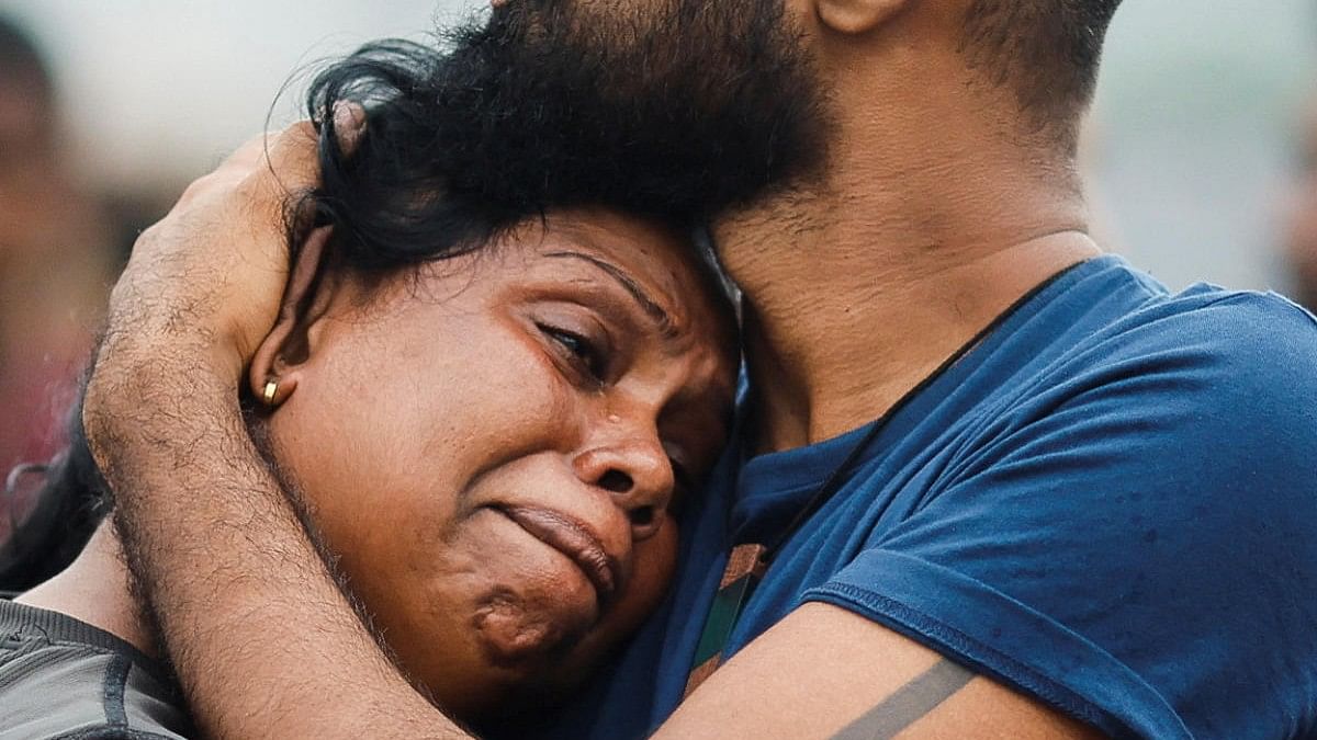 <div class="paragraphs"><p>A protester cries as she is consoled by a fellow demonstrator after a raid on an anti-government protest camp early on Friday, amid the country's economic crisis, in Colombo, Sri Lanka July 22, 2022.</p></div>