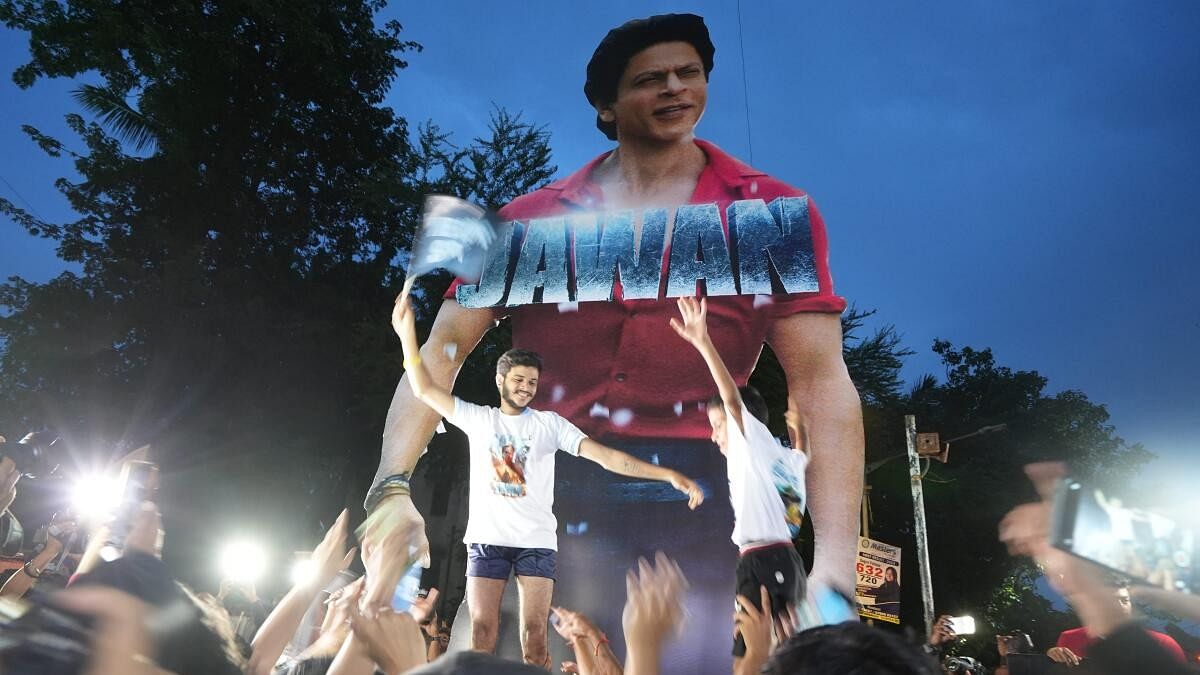 <div class="paragraphs"><p>Fans form a human pyramid near a poster of Bollywood actor Shah Rukh Khan outside a cinema hall as they arrive to watch the screening of his latest film "Jawan'.</p></div>