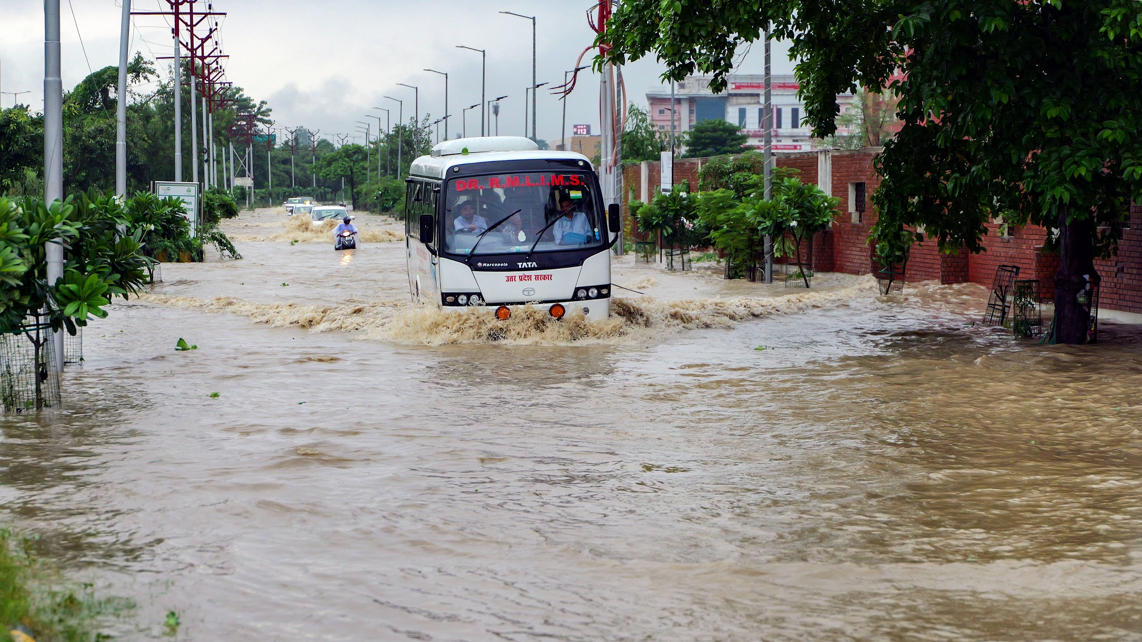 <div class="paragraphs"><p>Vehicles pass through a waterlogged road after heavy rains, in Gomti Nagar area in Lucknow.&nbsp;</p></div>