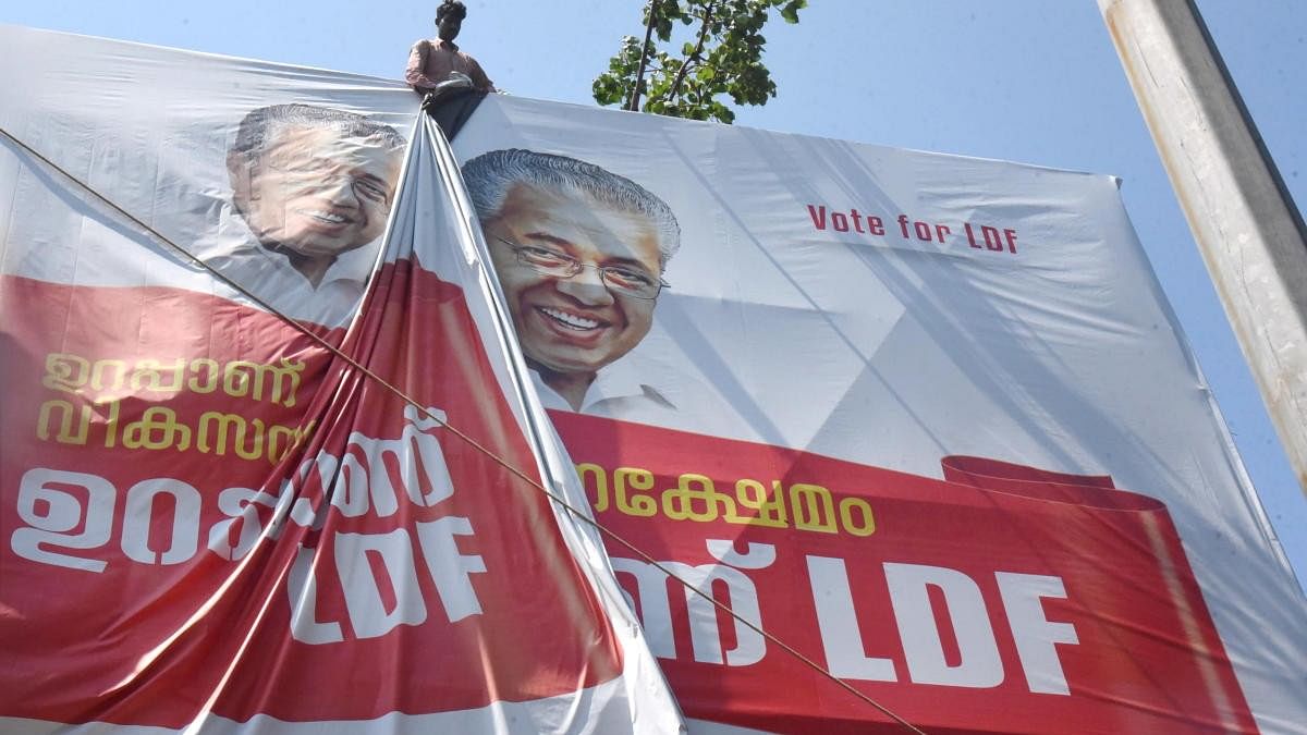 <div class="paragraphs"><p>A worker puts up an election campaign banner of Kerala Chief Minister Pinarayi Vijayan.</p></div>