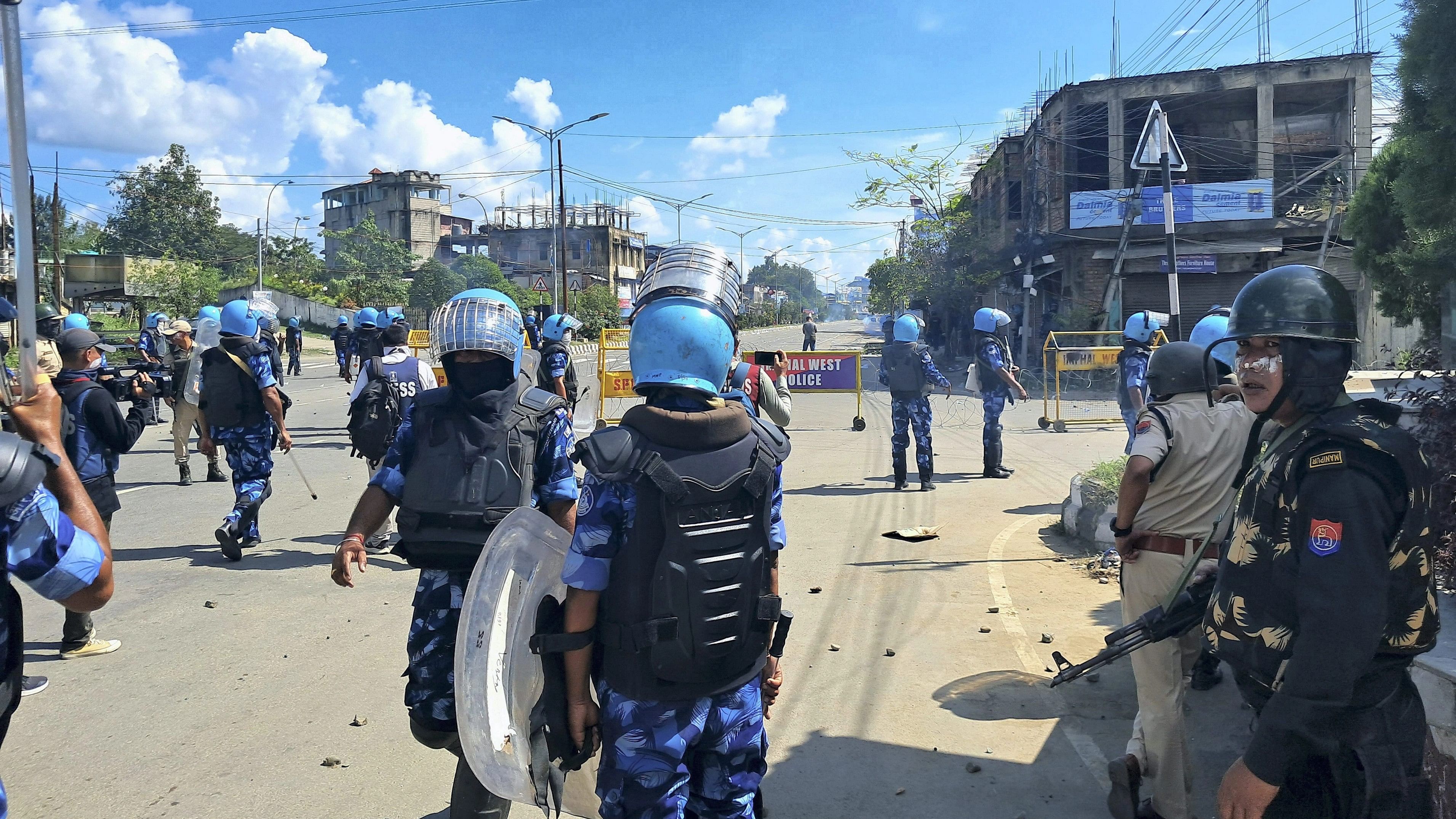 <div class="paragraphs"><p>Security personnel stand guard during a protest rally by school students against the killing of two Meitei youths by suspected Kuki Zo militants, at Moirangkhom in Imphal West district, Wednesday, Sept. 27, 2023. </p></div>