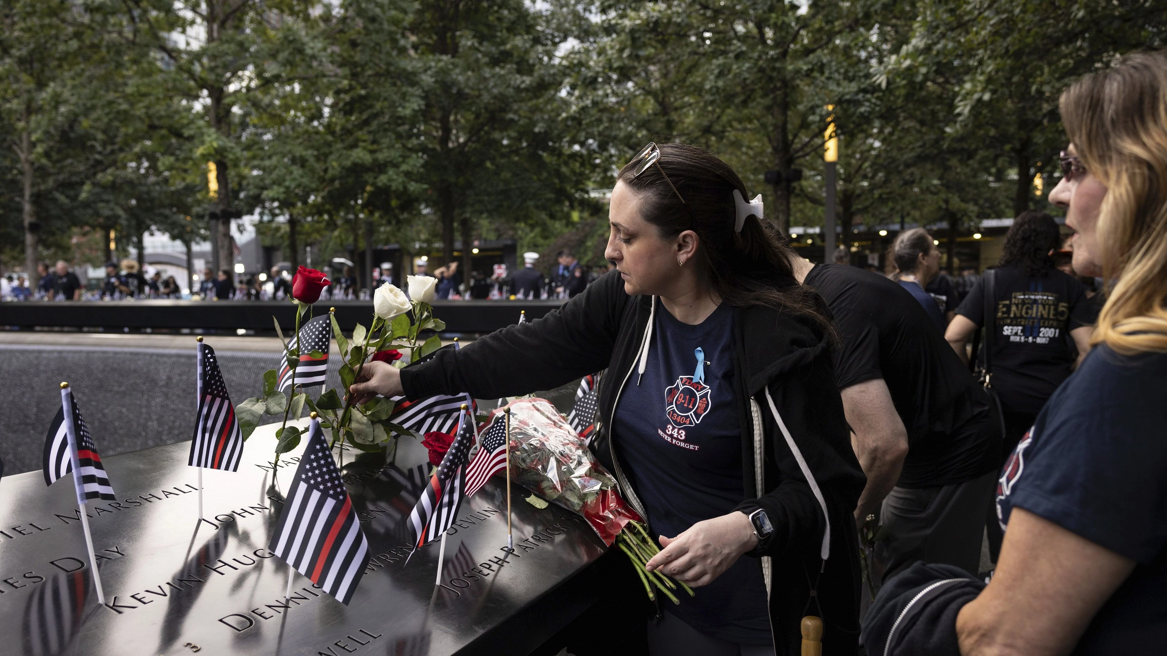 <div class="paragraphs"><p>Family members put flowers on the 9/11 Memorial during the commemoration ceremony on the 22nd anniversary on Monday. </p></div>