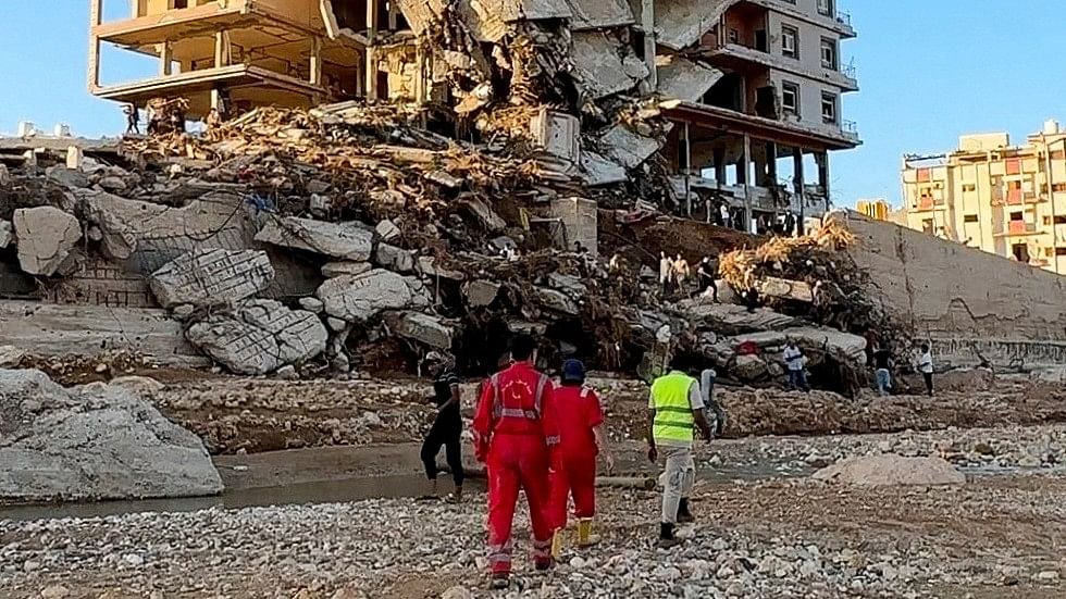 <div class="paragraphs"><p>Emergency members work near a damaged building after a powerful storm and heavy rainfall hit Libya, in Derna, Libya, September 12, 2023 in this still image from video obtained from social media. </p></div>