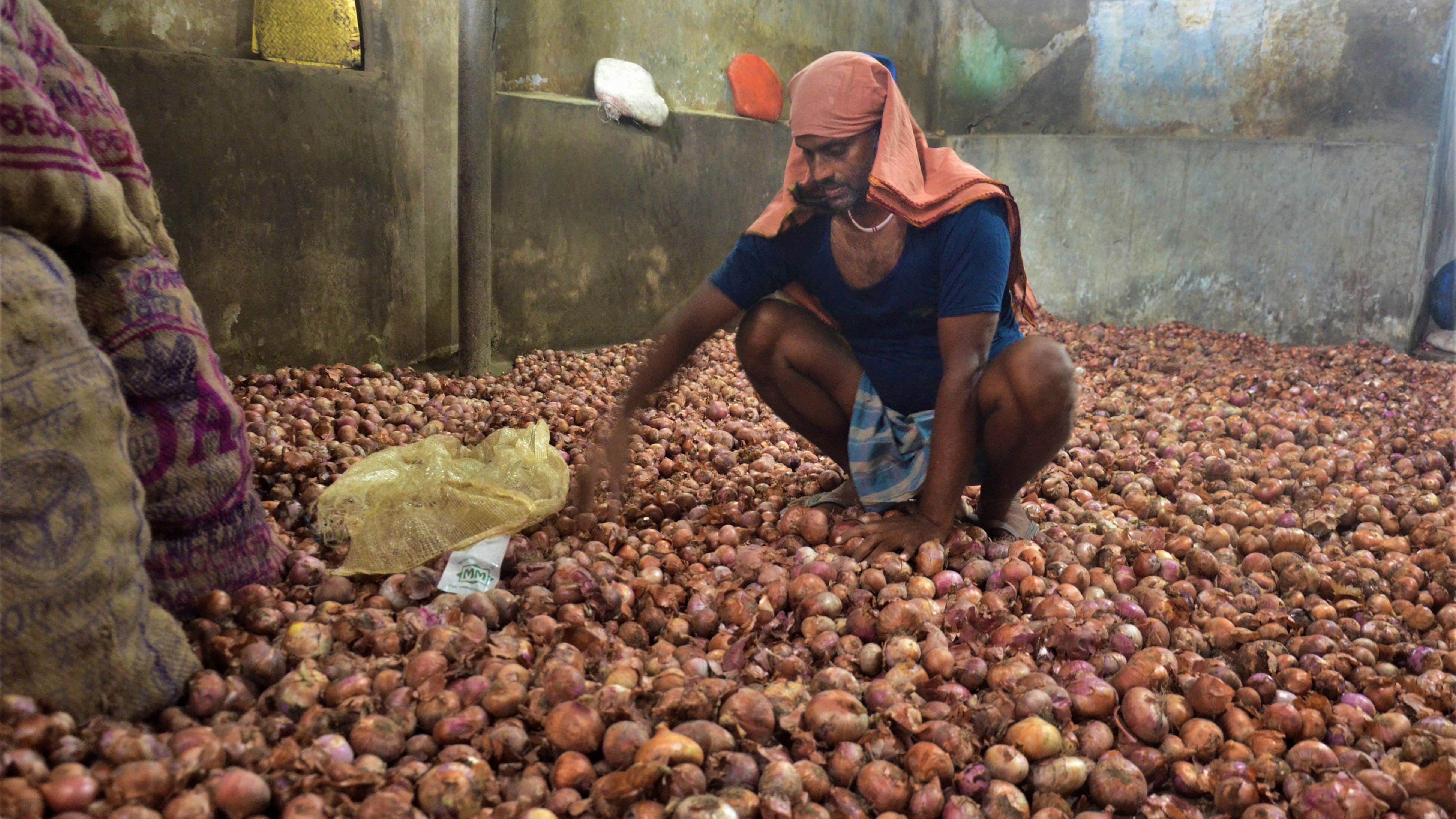 <div class="paragraphs"><p>A worker sorts onions at a godown in Dibrugarh.</p></div>