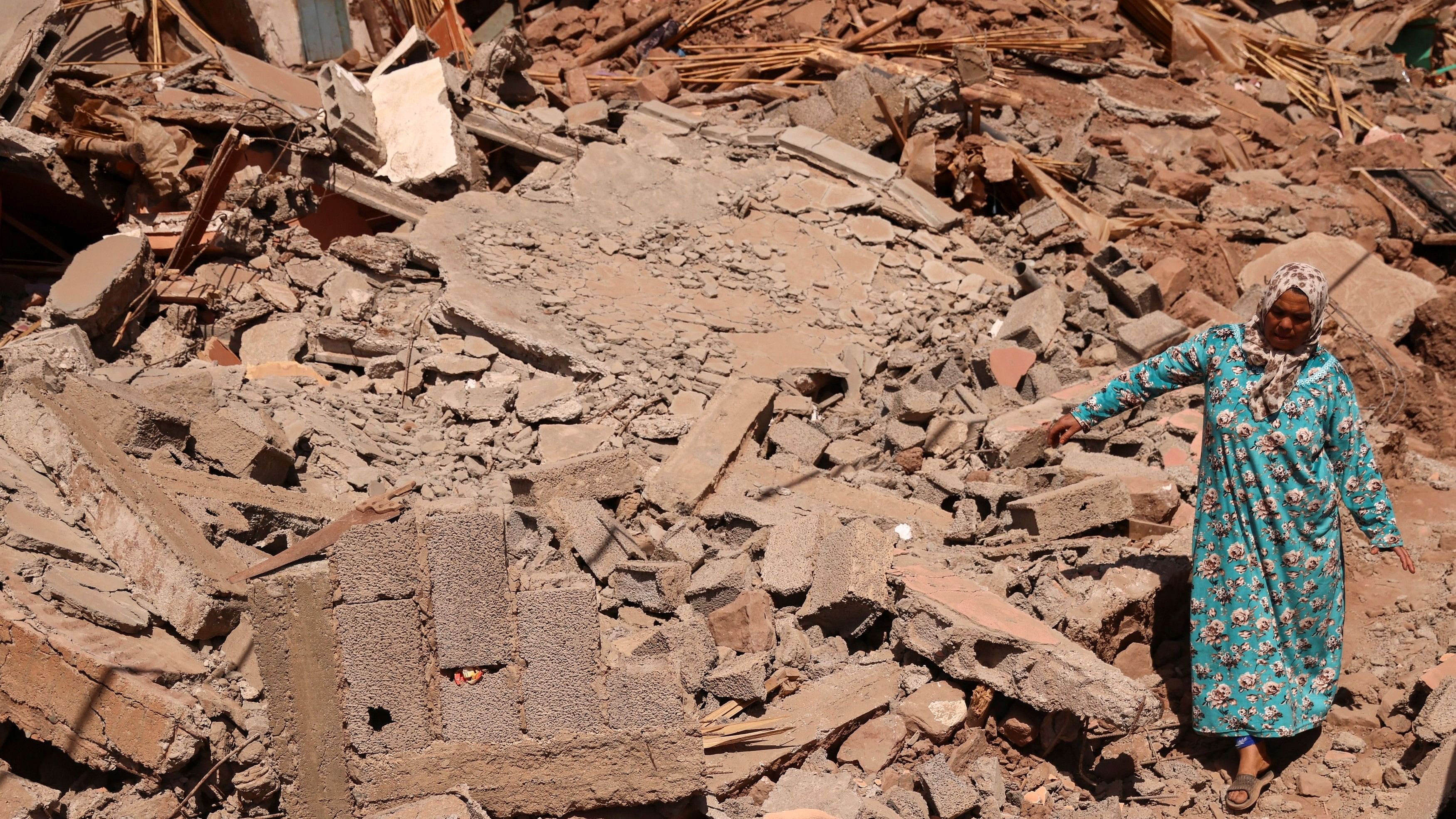 <div class="paragraphs"><p>A woman walks amid rubble in the aftermath of a deadly earthquake in Talat N'Yaaqoub, Morocco.&nbsp;</p></div>