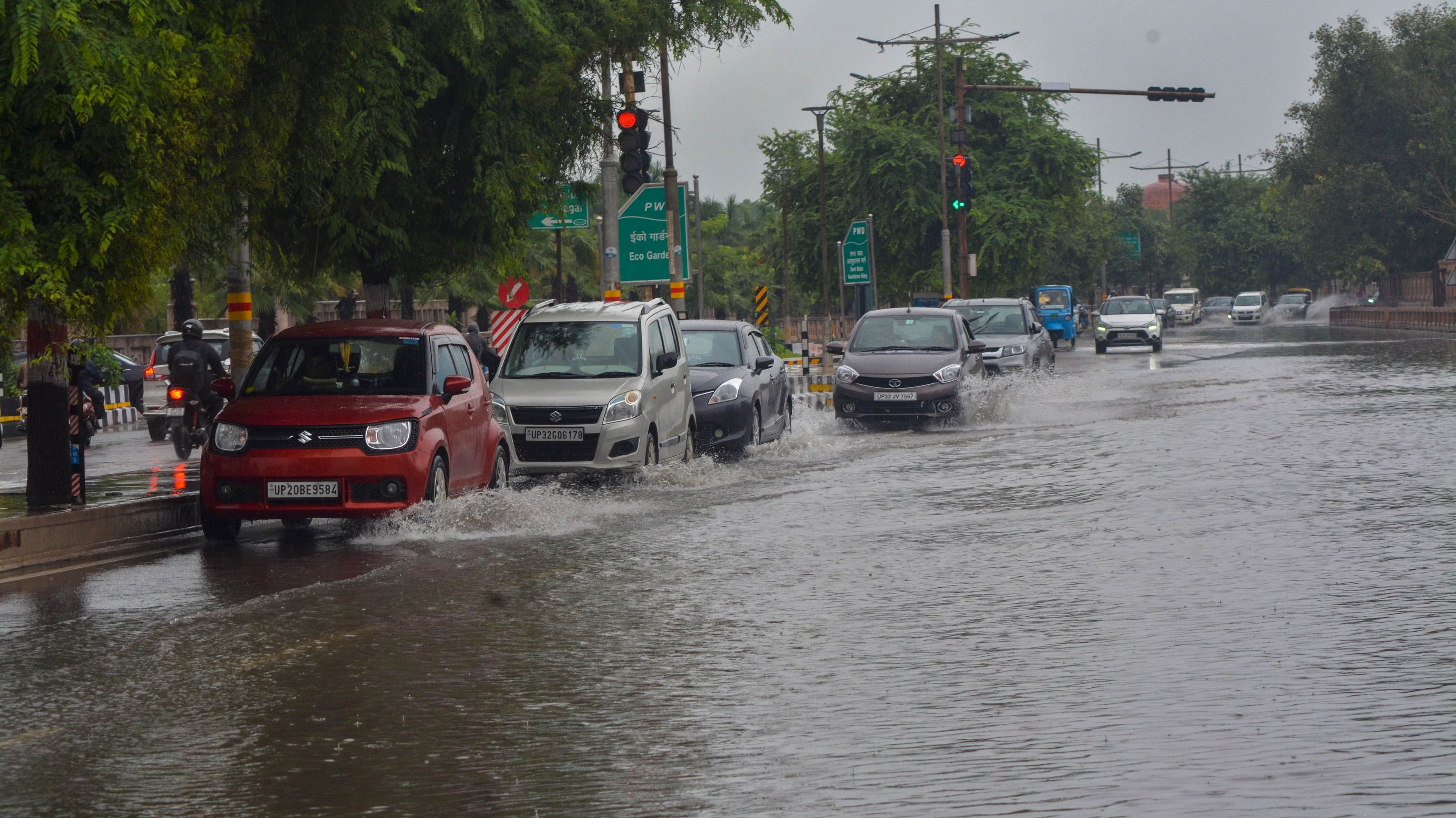 <div class="paragraphs"><p>Vehicles wade through a waterlogged road following heavy rains in Lucknow.&nbsp;</p></div>