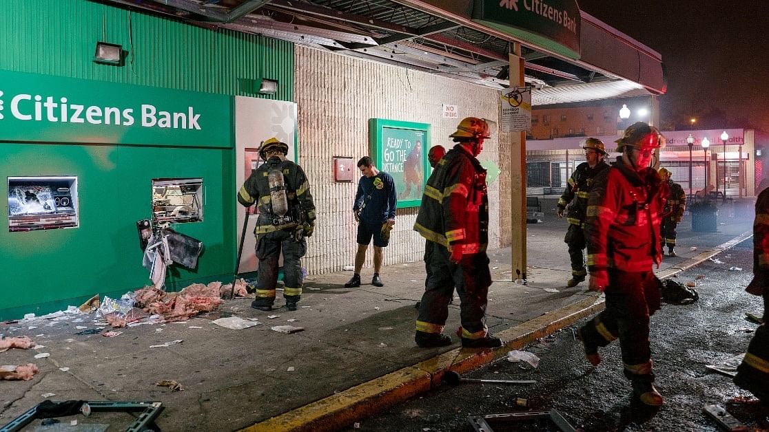 <div class="paragraphs"><p>Police officers and firemen respond to small fire and  broken ATM machine following protests in Philadelphia.</p></div>