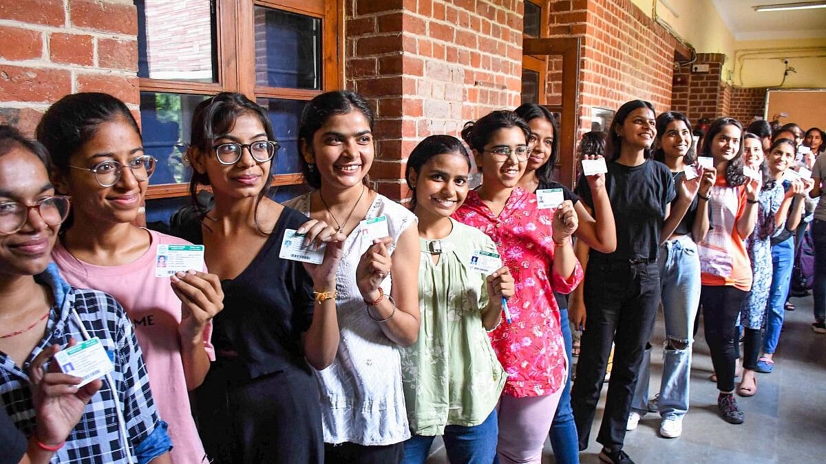 <div class="paragraphs"><p>Students show their identification cards as they arrive to cast their votes for the Delhi University Students' Union (DUSU) polls 2023, at Miranda House college.</p></div>