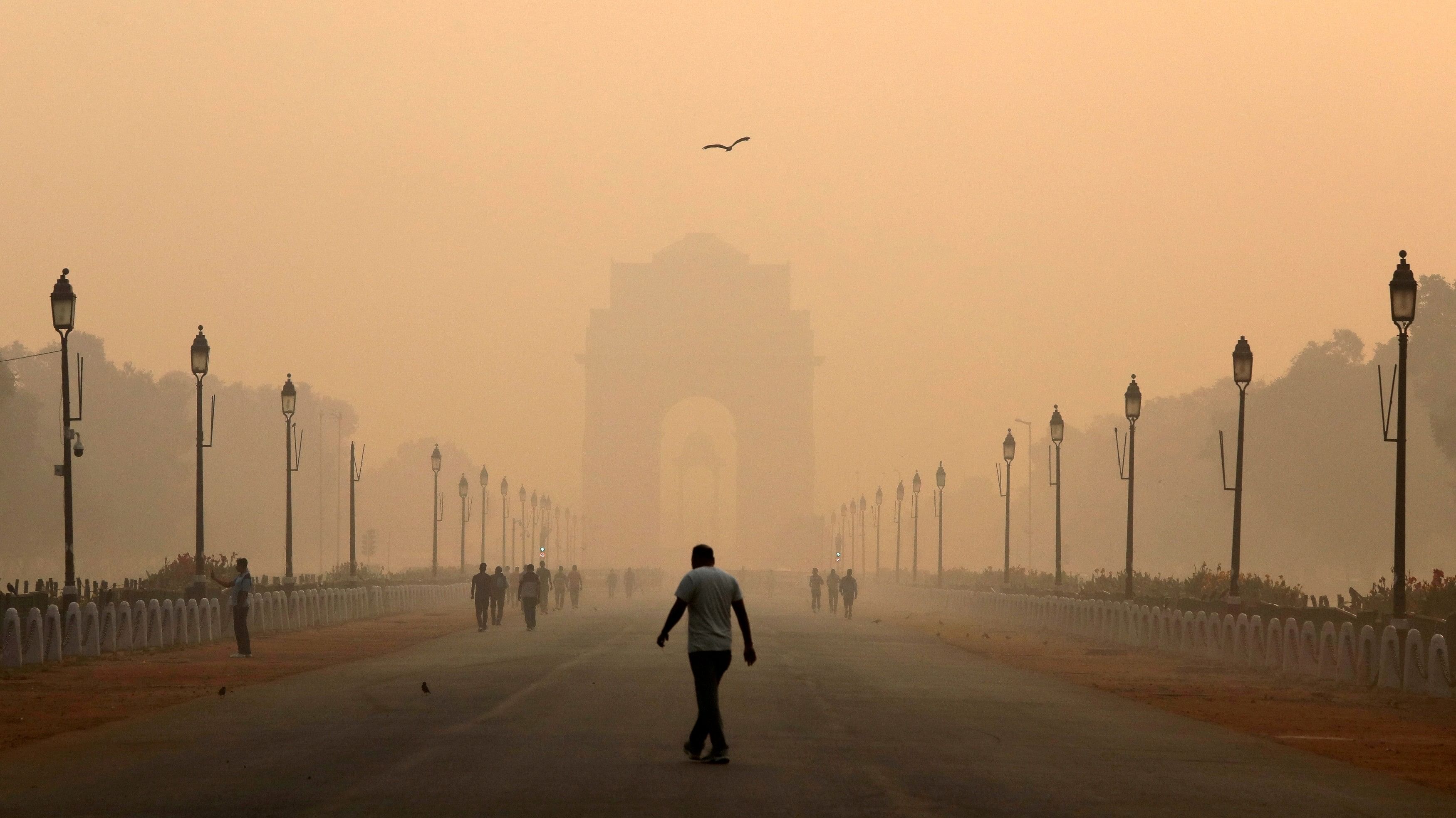 <div class="paragraphs"><p>A man walks in front of India Gate shrouded in smog in New Delhi.</p></div>