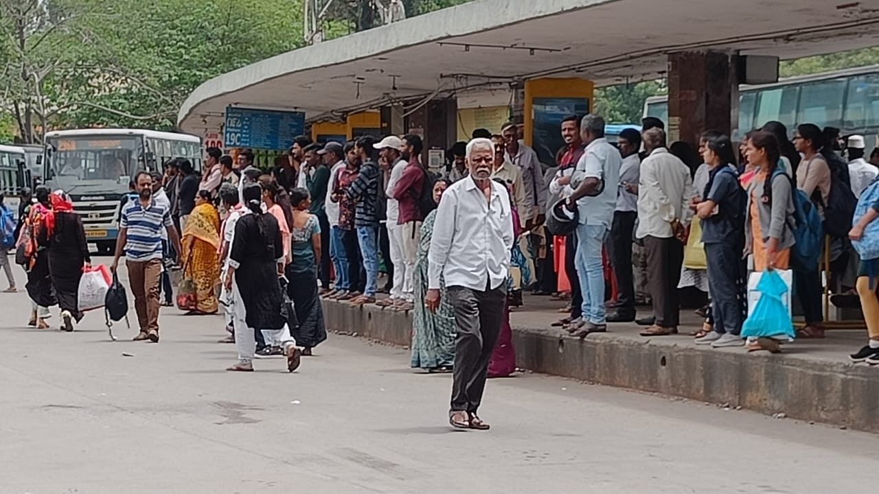 <div class="paragraphs"><p>Commuters wait for their buses at the BMTC bus stand at Majestic.</p></div>