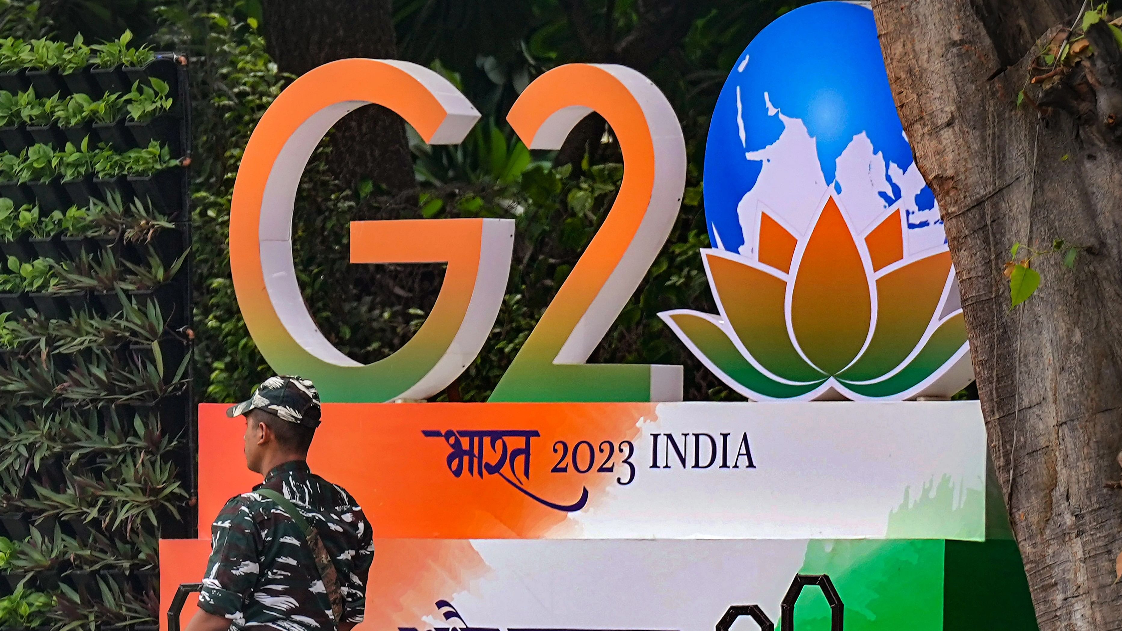 <div class="paragraphs"><p>A security personnel stands guard opposite a G20 logo installed near Raisina Road as part of preparations for the upcoming summit, in New Delhi.</p></div>