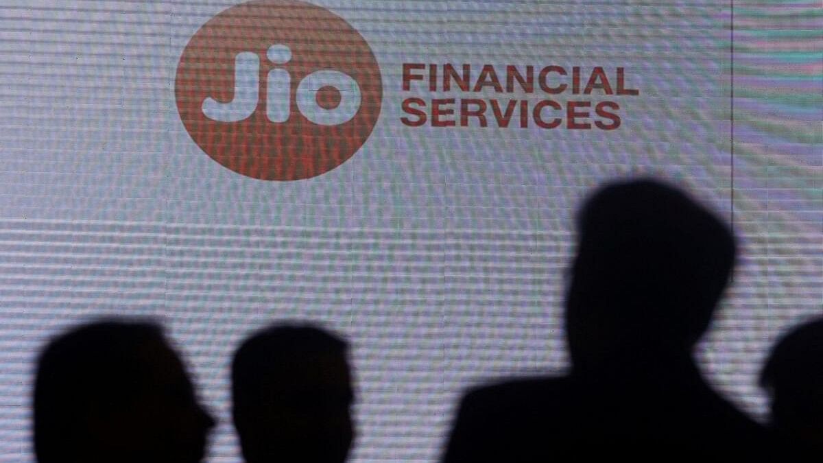 <div class="paragraphs"><p>People stand next to a logo of Jio Financial Services ahead of its listing ceremony at the Bombay Stock Exchange in Mumbai.</p></div>