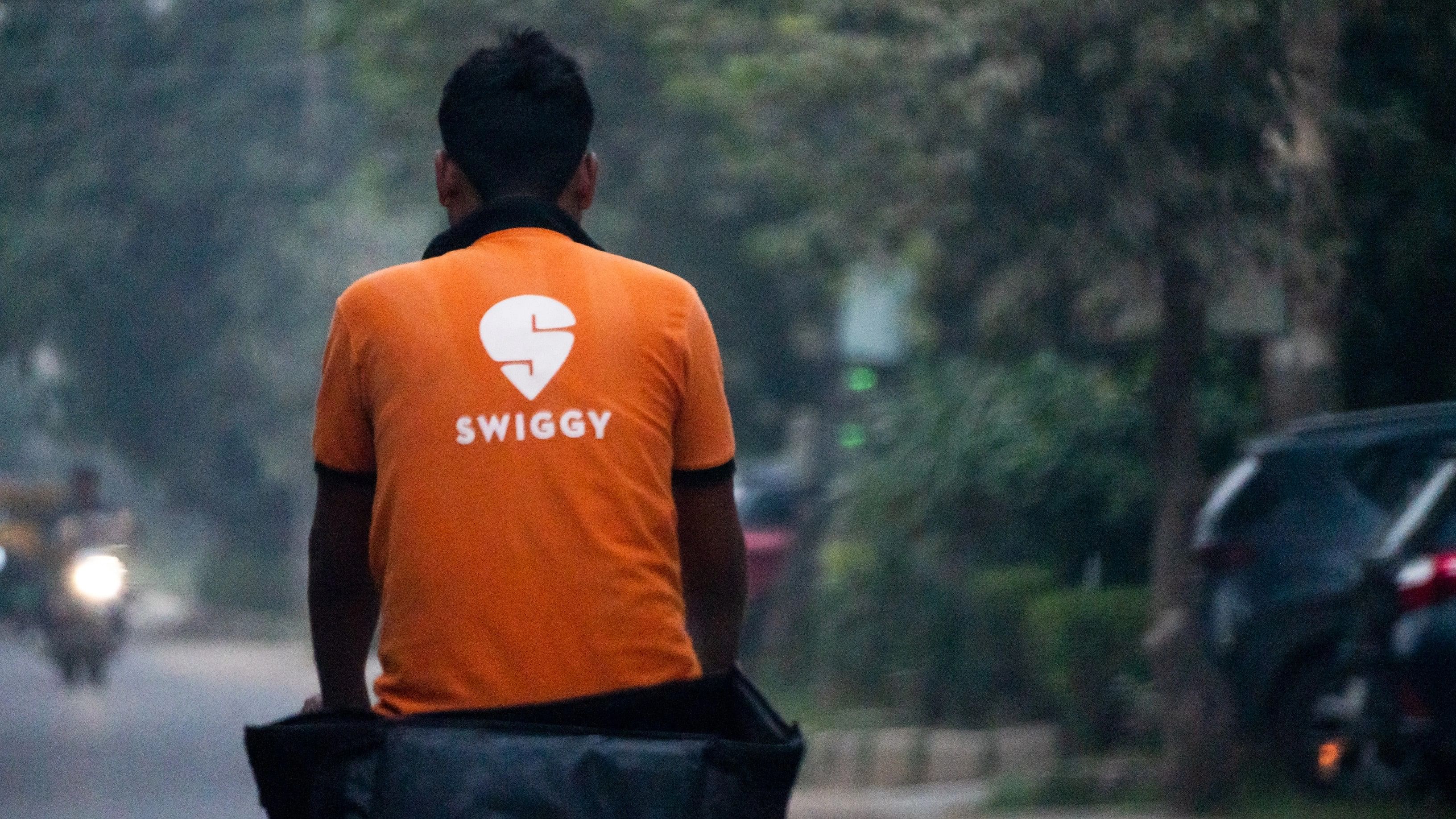 <div class="paragraphs"><p>The Swiggy logo pictured on the back of a delivery executive.</p></div>