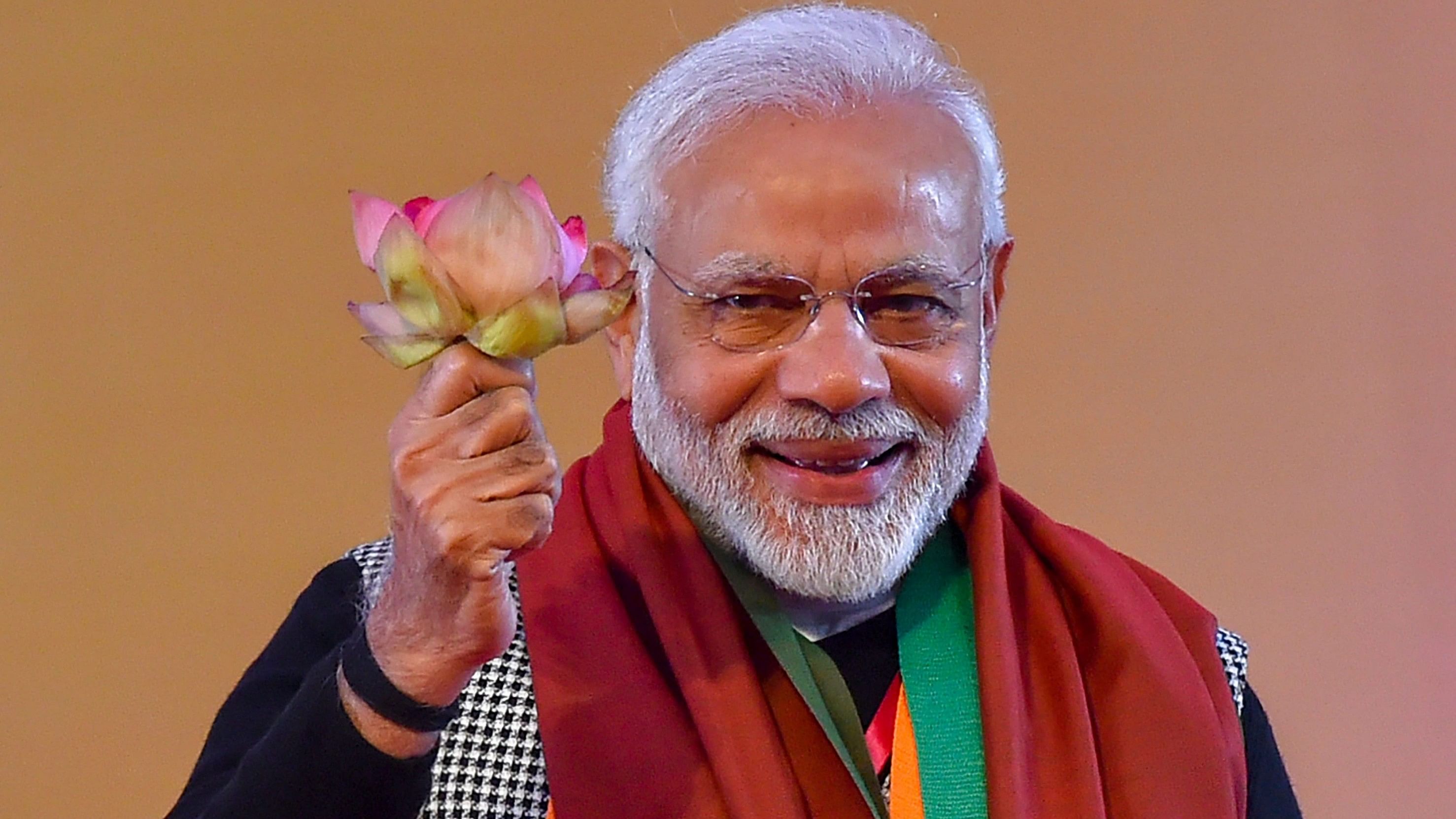 <div class="paragraphs"><p>Prime Minister Narendra Modi holds a lotus flower.&nbsp;</p></div>