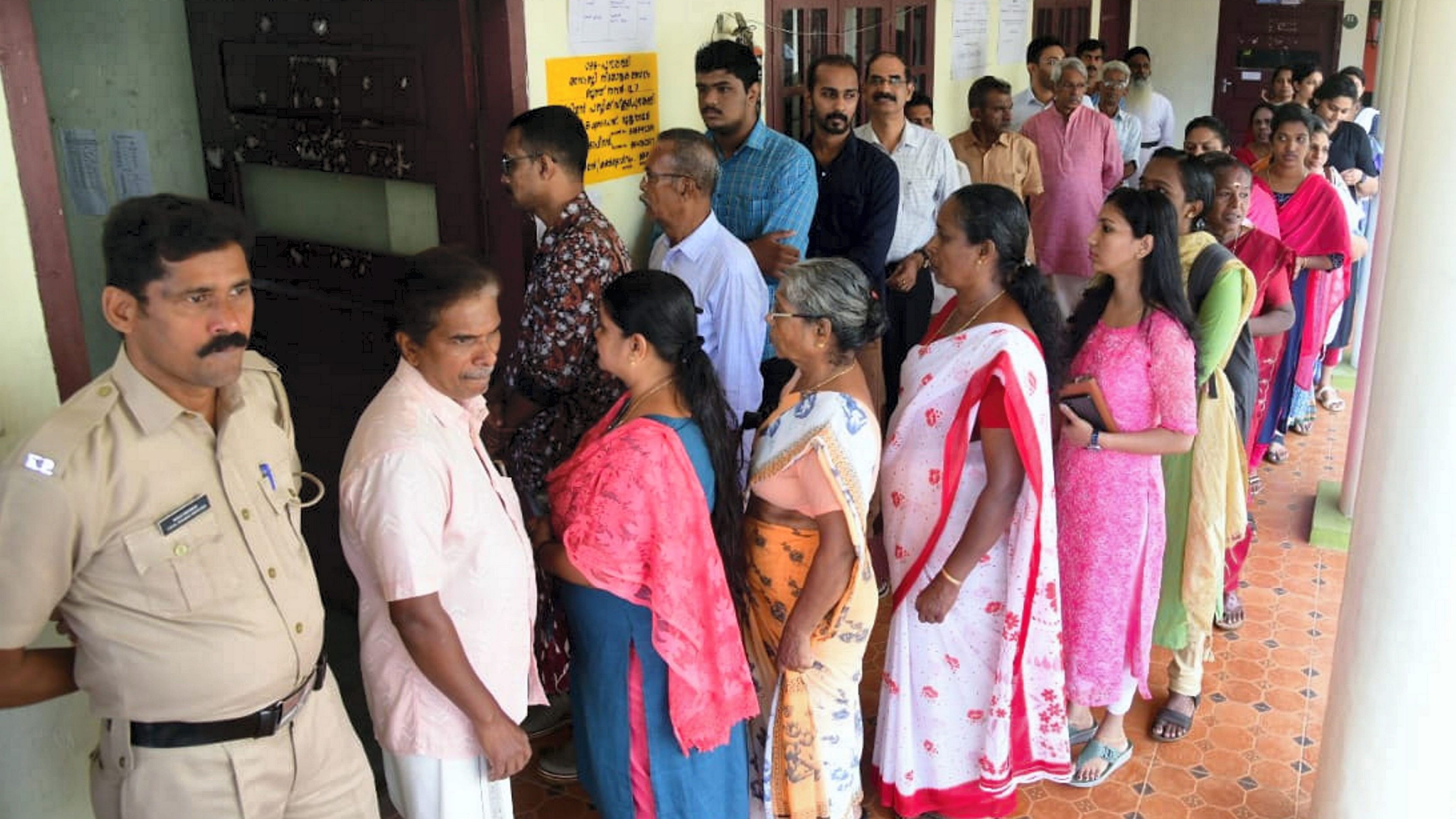 <div class="paragraphs"><p>Voters wait in a queue to cast their votes during the by-elections to Puthuppally assembly seat, in Kerala's Kottayam district.&nbsp;</p></div>