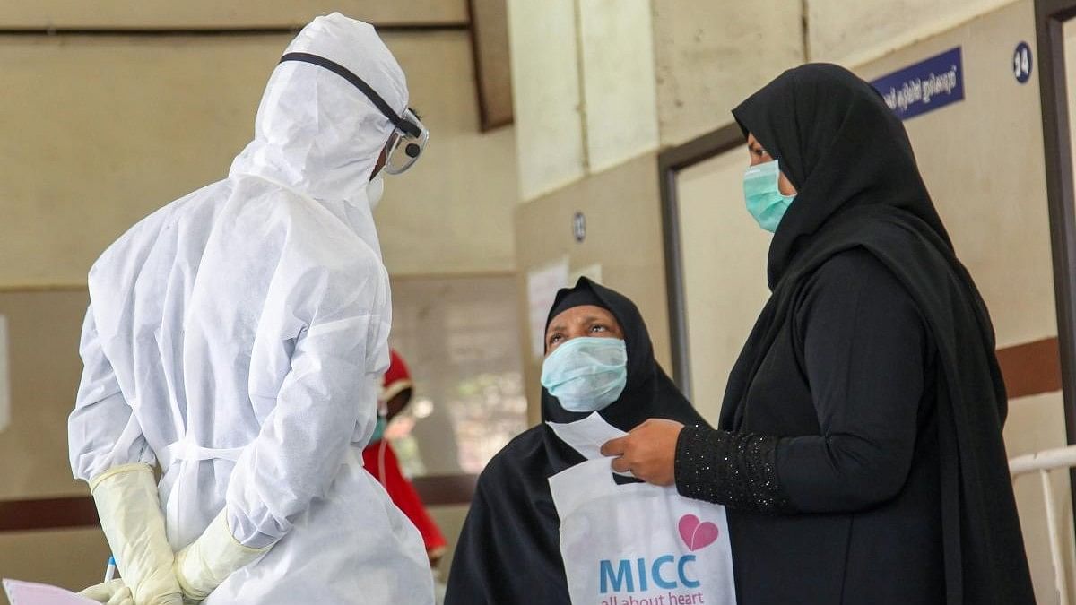 <div class="paragraphs"><p>Doctors and patients wear safety masks as a precautionary measure after the Nipah virus outbreak, at a medical college in Kozhikode, Kerala. </p></div>