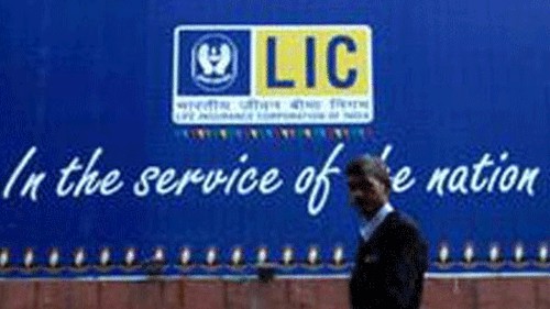 <div class="paragraphs"><p>A man walks in front of the LIC logo. </p></div>