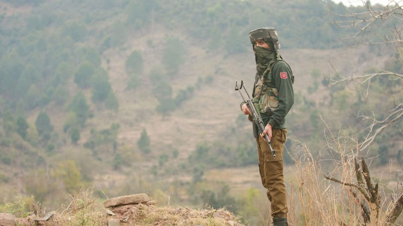 <div class="paragraphs"><p>A security personnel stands guard after the twin terror attacks at Dangri village in Rajouri district. </p></div>