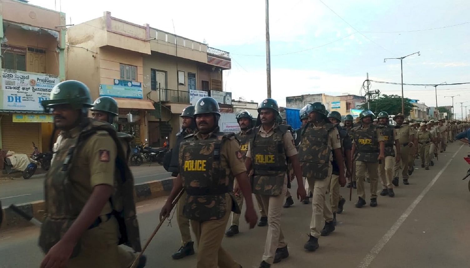 Police take out a flag march in Srinivaspur of Kolar district on Sunday.