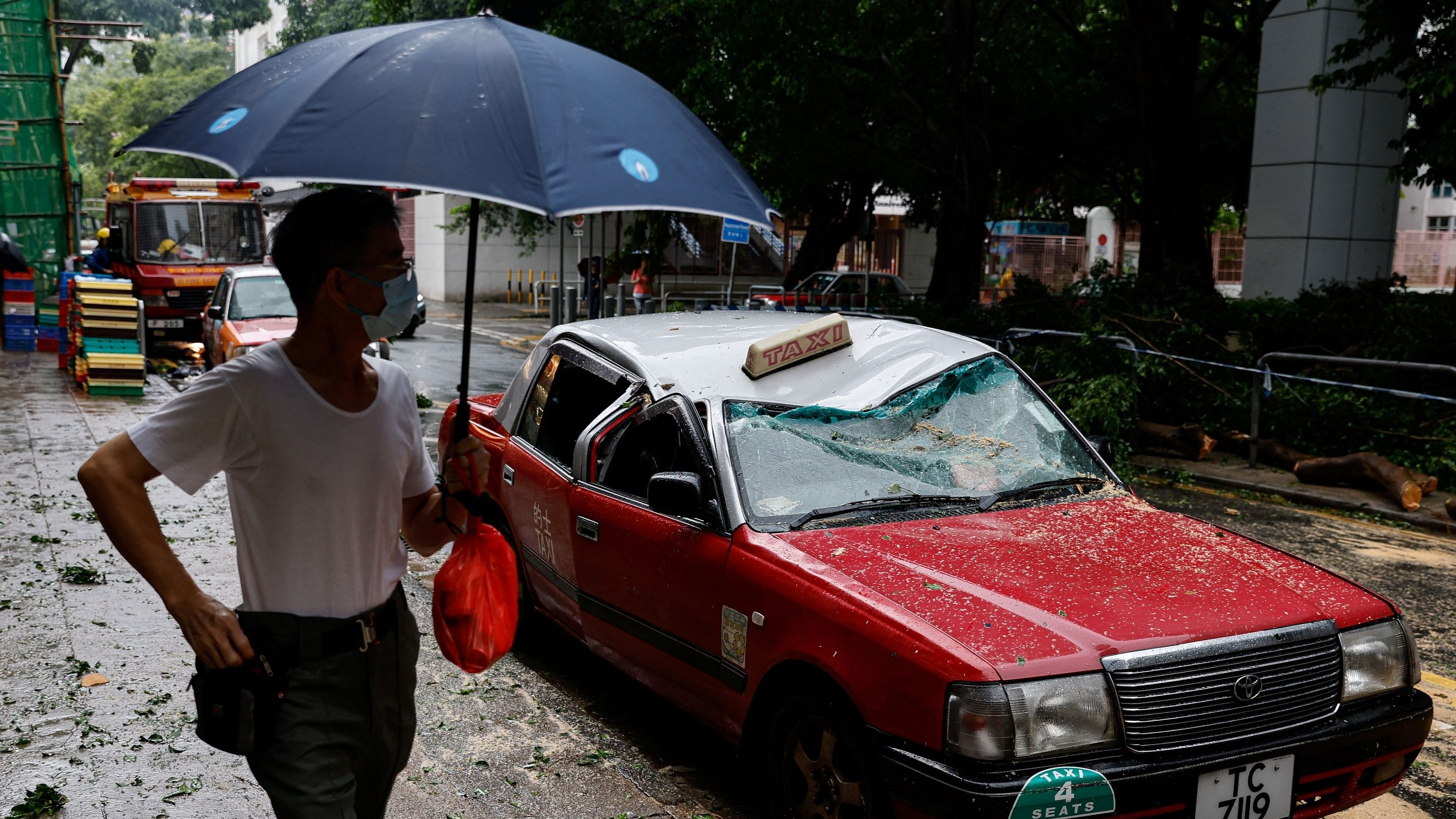 <div class="paragraphs"><p>A taxi damaged by fallen trees is seen following Super Typhoon Saola in Hong Kong.</p></div>