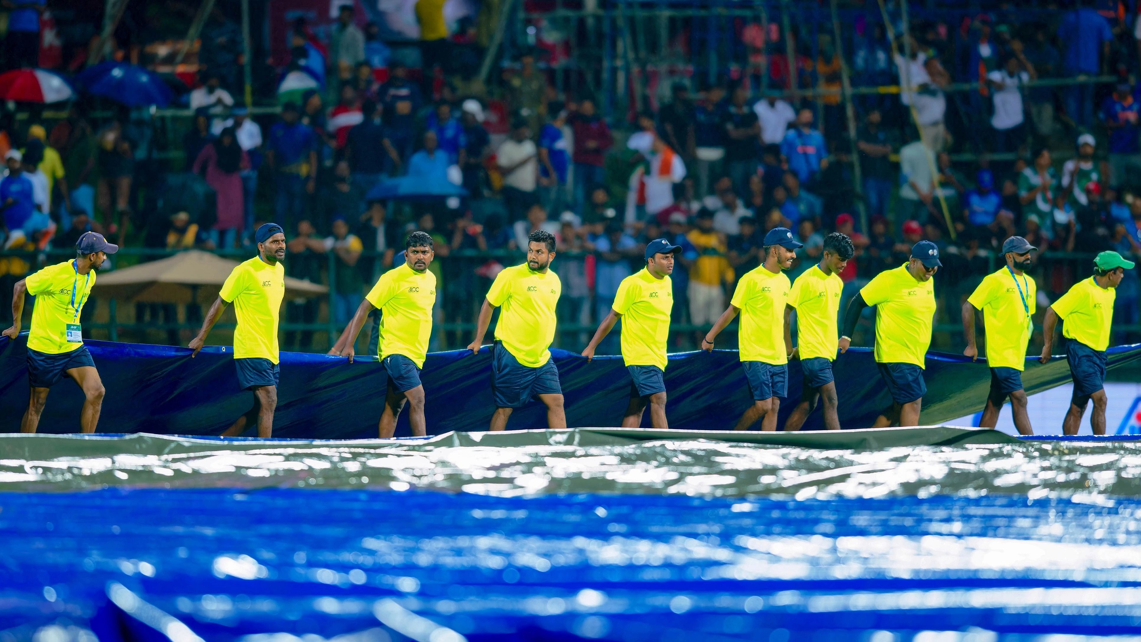 <div class="paragraphs"><p>Groundsmen cover the pitch as it rains during the Asia Cup match between India and Pakistan, at Pallekele International Cricket Stadium in Sri Lanka.</p></div>