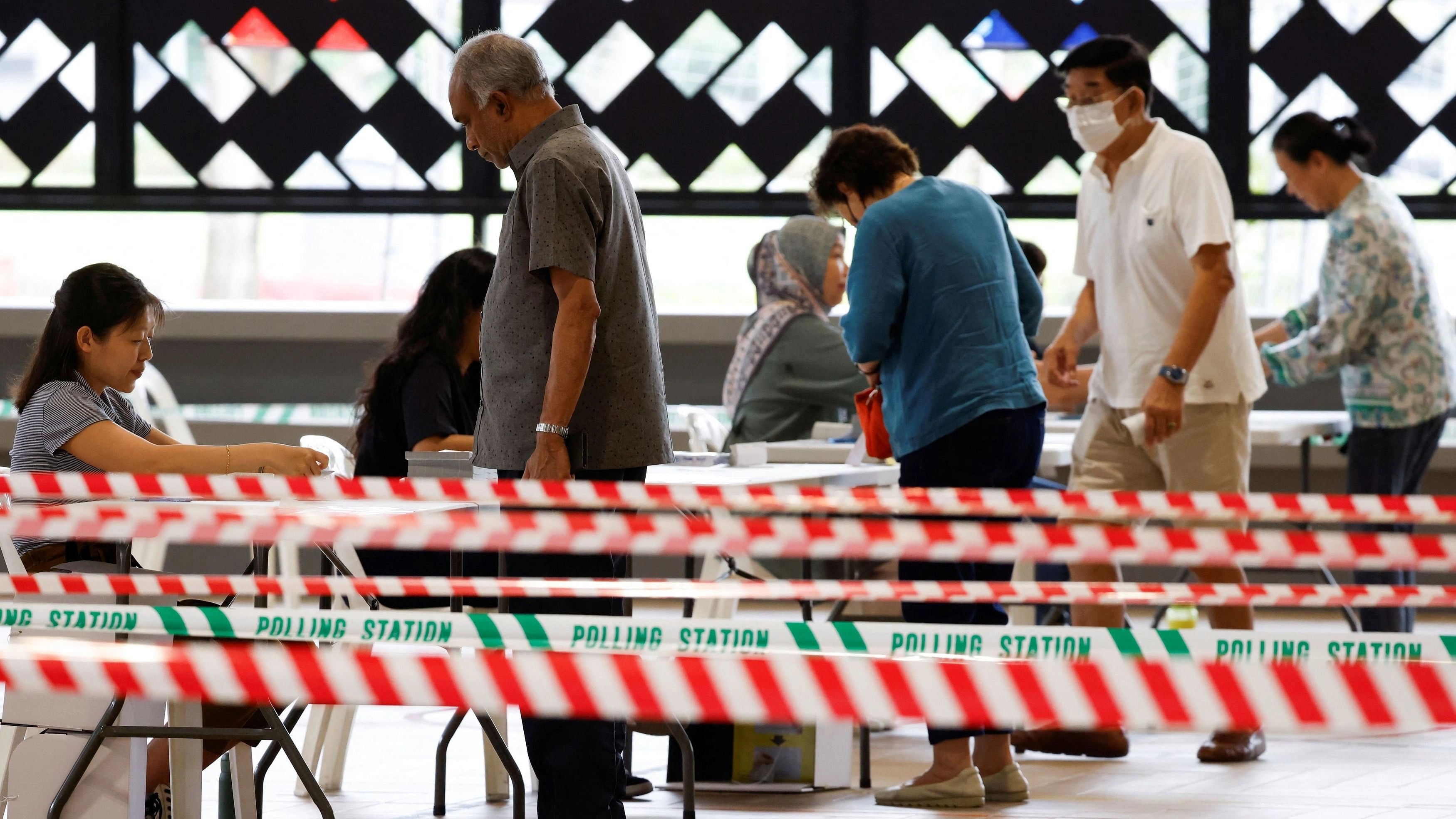 <div class="paragraphs"><p>Voters wait in line to cast their ballots at a polling center during the presidential election in Singapore September 1, 2023.</p></div>