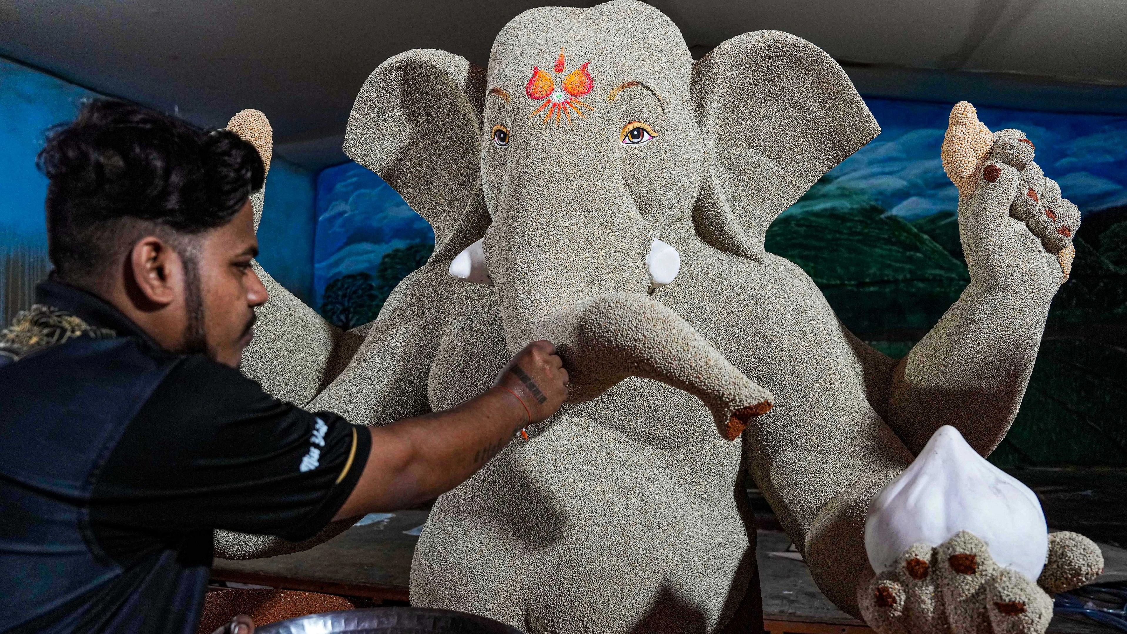 <div class="paragraphs"><p> An artist gives final touch to an idol of Lord Ganesha, made using grains, ahead of the Ganesh Chaturthi festival, in Mumbai, Saturday, Sept. 16.</p></div>