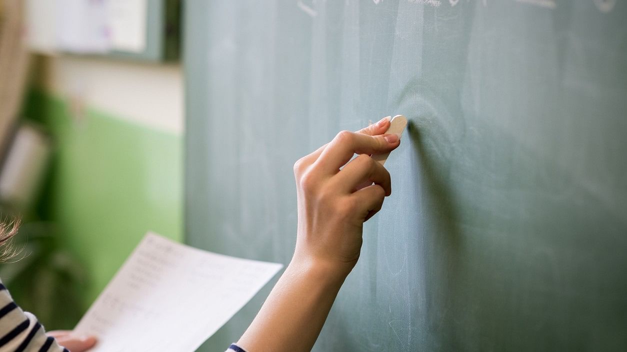 <div class="paragraphs"><p>Representative image of a teacher writing on blackboard</p></div>