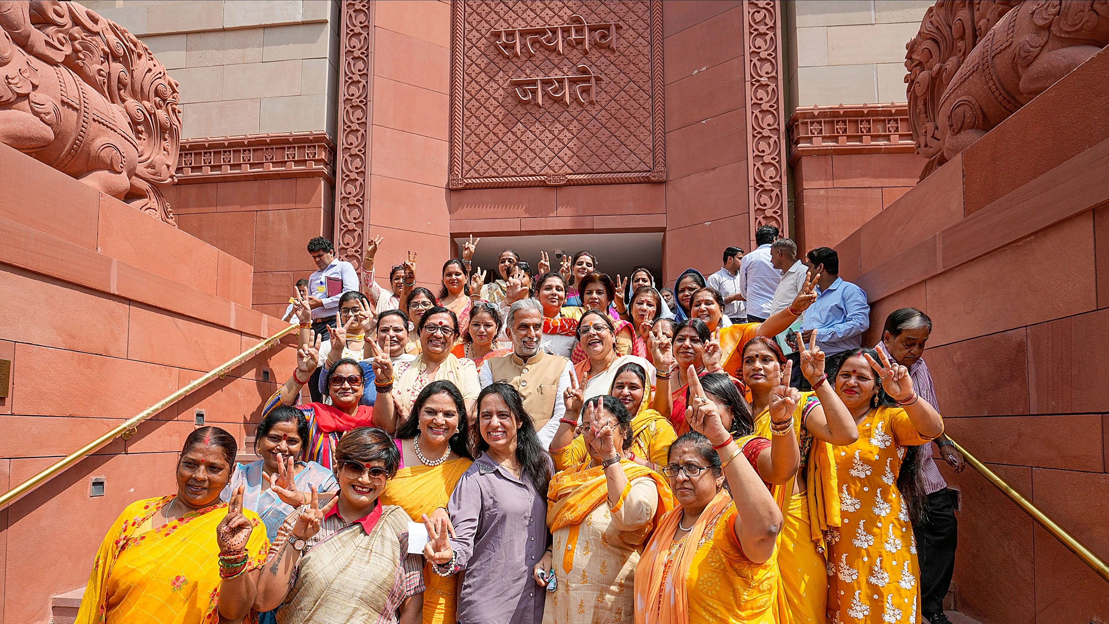 <div class="paragraphs"><p>BJP MP Krishan Pal Gurjar with women visitors at the Parliament House during the special session, in New Delhi.</p></div>