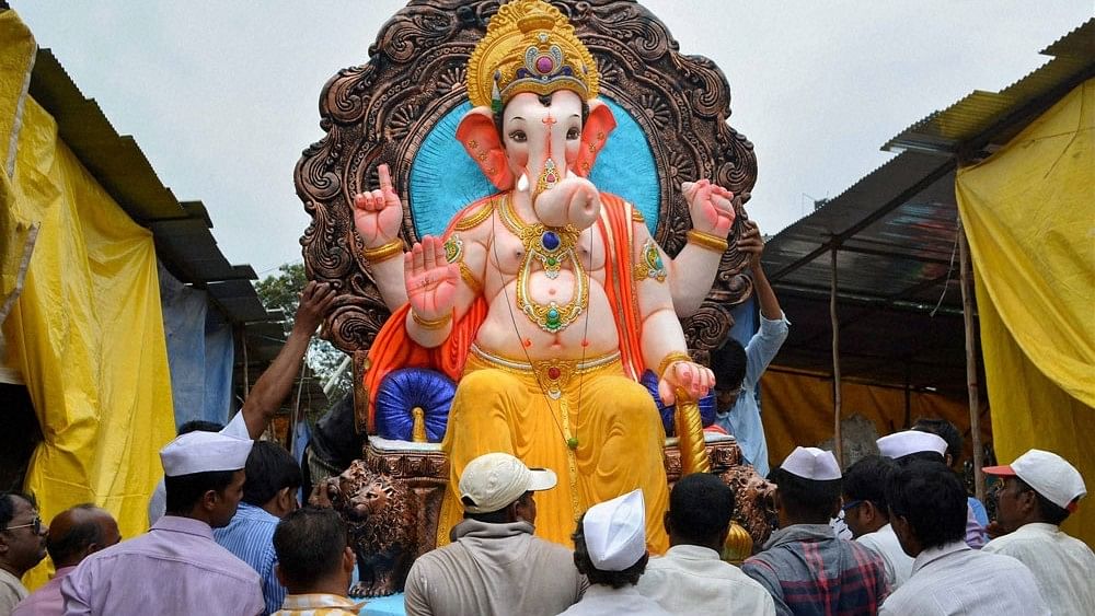 <div class="paragraphs"><p>Members of Sarvajanik Ganeshotsav Mandal carrying an idol of Lord  Ganesha to the pandal on the eve of Ganesh Chaturthi festival in Karad,  Maharashtra on Wednesday. </p></div>