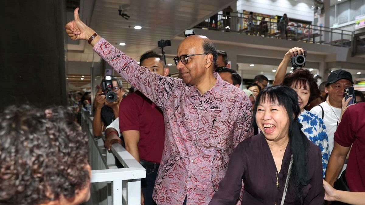 <div class="paragraphs"><p>Presidential candidate Tharman Shanmugaratnam and his wife Jane Ittogi meet supporters after polling has concluded at the presidential elections in Singapore.&nbsp;</p></div>