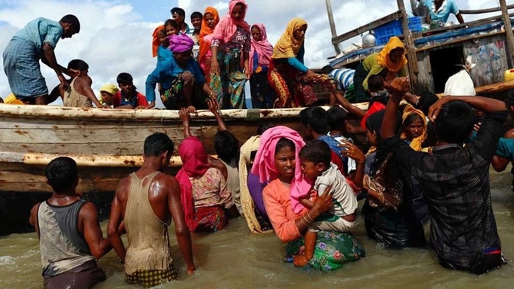 <div class="paragraphs"><p>Rohingya refugees get off a boat after crossing the Bangladesh-Myanmar border through the Bay of Bengal, in Shah Porir Dwip, Bangladesh. </p></div>